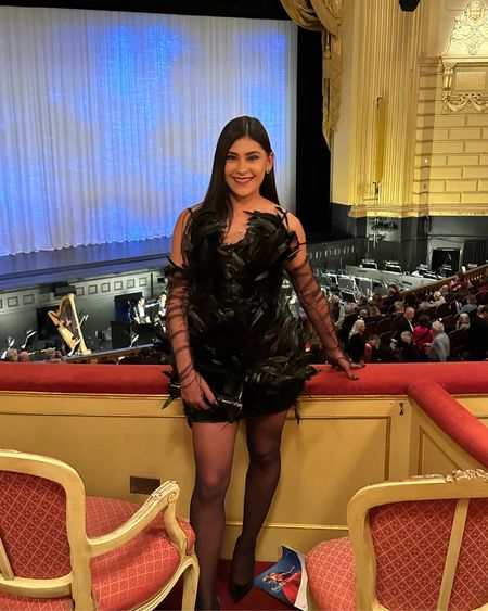 Last night we were honored to attend Swan Lake 🦢 at @SFBallet! It was a breathe taking show. The dancing 🩰 was on another level (as always), and the costumes and music 🎶 were simply stunning 🤩. Y’all know I love mixing high and low fashion…I have been eyeing this 🪶 dress for months but simply didn’t buy it because I didn’t have an occasion to wear it. I was lucky because there was only one left in my size when we got our ballet tickets, and it was PERFECT for the occasion. I paired it with emerald jewelry 💎, black sheer stockings and matching opera gloves 🖤. I originally planned to wear the 👗 with feather embellished high heel sandals, but Emilio told me to “take it off,” when I tried on the ensemble in front of him 🤭. He thought it was scary that mommy looked a little too bird-like 🦅! The kid doesn’t miss a THING and is very honest. I took a hint that it was maybe too costume-y and swapped the sandals for a classic black pump 👠. Do you like how it turned out?! 