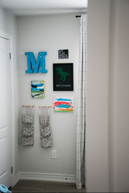 Gallery wall for little boys room including his own art on wood canvas frames, a large aluminum initial letter, clothes storage hanging baskets and checkered linen blackout curtains  

#LTKkids #LTKhome #LTKFind