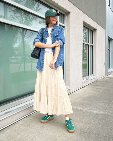 Layered spring outfit with pops of green! 
My maxi skirt is starting to sell out but I also linked similar - so easy to wear for spring and summer. I’m 5’ 7” wearing size S.
My denim shirt is a men’s XL, I wanted it really big. 
My sneakers are a fun way to add a pop of color, tons of different colors are available, this green is mostly sold out. I always size down 1/2 size in this style (1.5 sizes if it’s men’s sizing)


#LTKStyleTip #LTKShoeCrush #LTKOver40