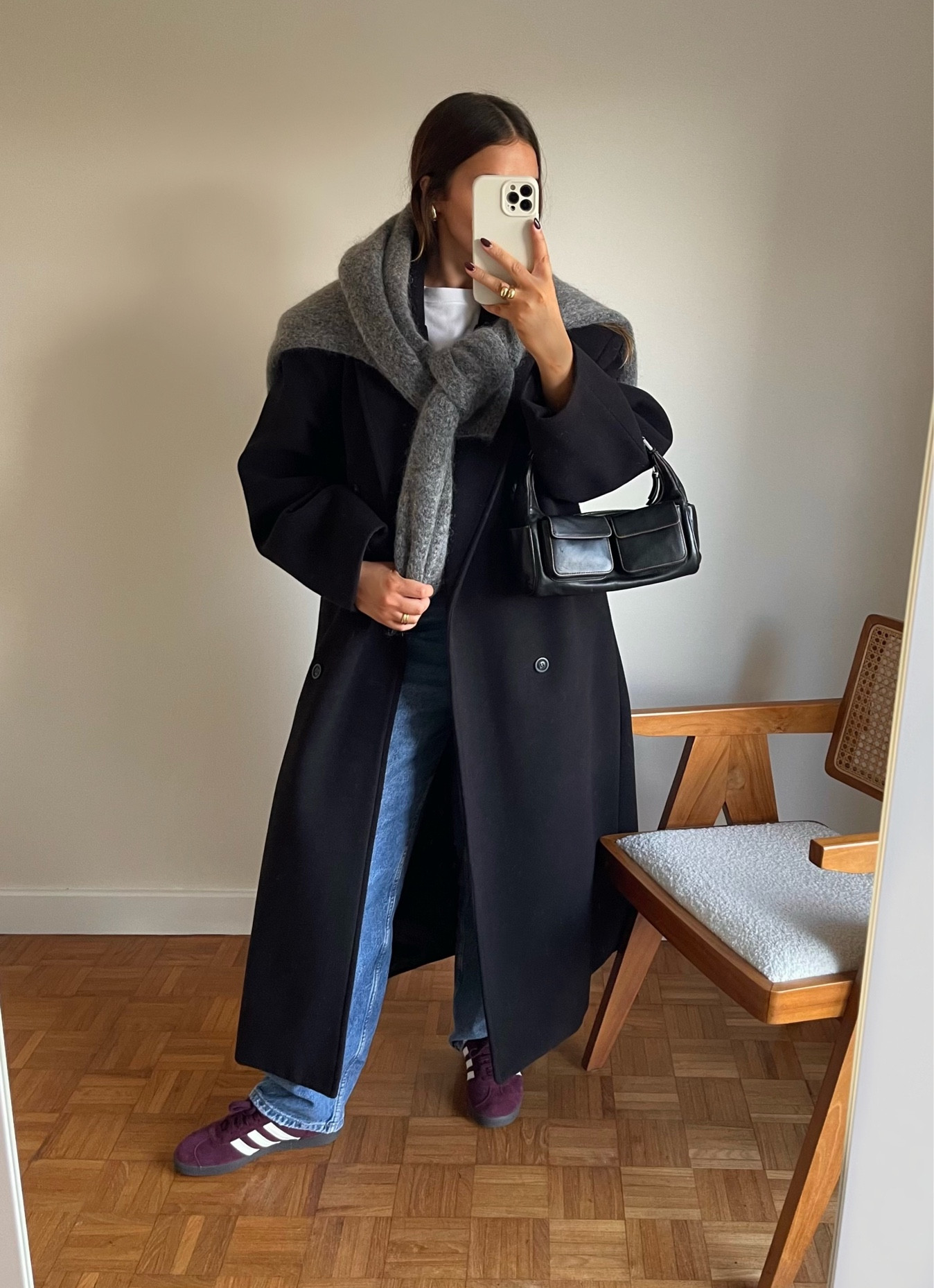 long black coat, grey knit jumper, blue jeans, burgundy adidas gazelles 