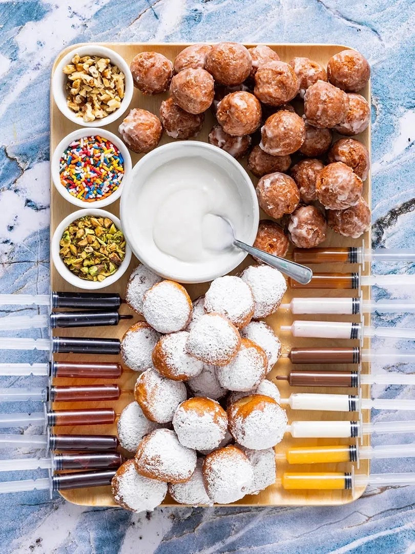 Christmas App Idea 

Ingredients
* 24-30 powdered or glazed donut holes
* Assorted fillings: strawberry jam, Nutella, lemon curd, cream cheese, caramel
* Assorted toppings: powdered sugar, sprinkles, chopped nuts
Instructions 
* Arrange bowls of toppings neatly on the board. 
* Place donuts on the board, making distinct piles of each type of donut. 
* Fill food-safe syringes or squeeze bottles with jams or fillings of your choice. 
* Invite guests to inject, dip, and decorate their own sufganiyot. 


#LTKHome #LTKHoliday #LTKSeasonal
