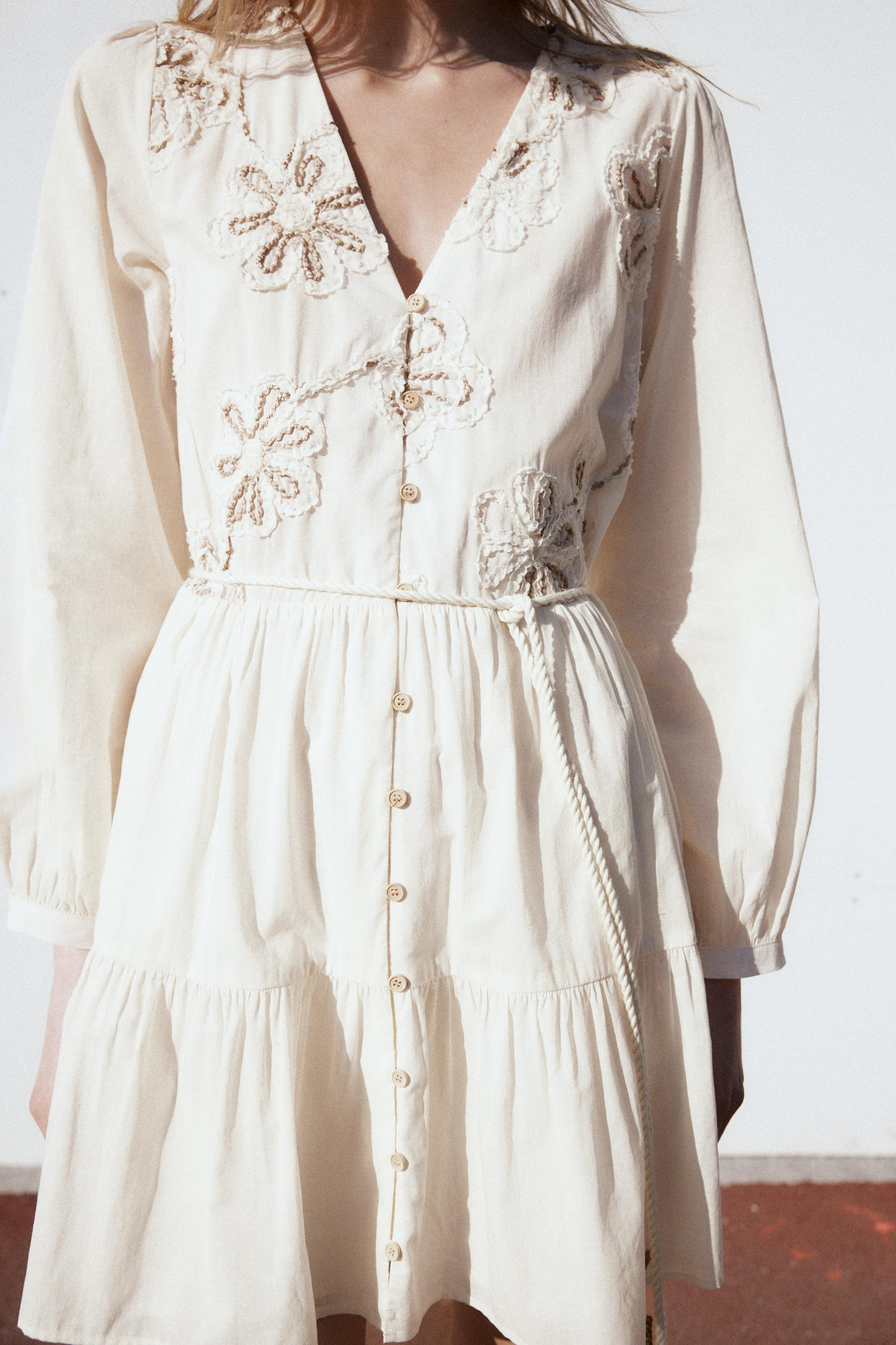 V-neck dress with long sleeves. Contrasting embroidered flowers and beaded cord belt with tassels... | Zara US