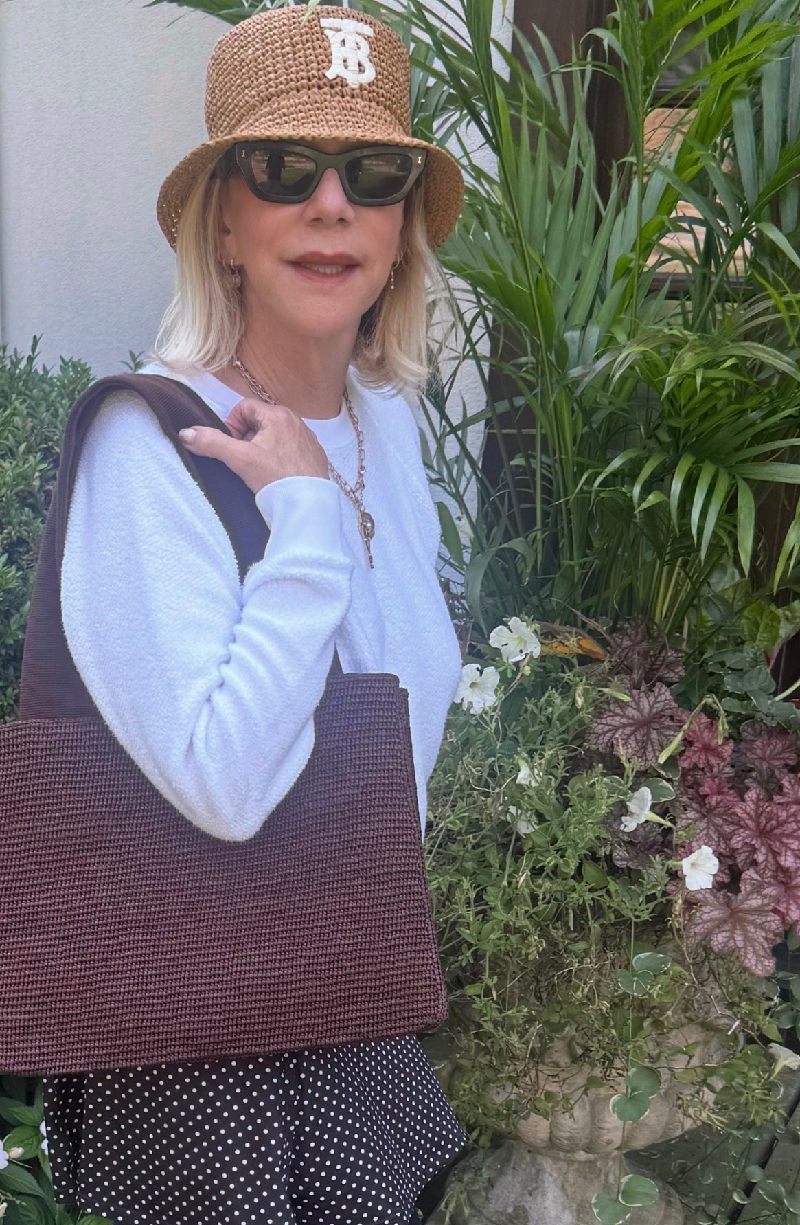 Burberry straw bucket hat, the perfect white tee, and my Row raffia tote. Burberry is always stylish. This tote is a true four-season bag — it comes with me everywhere, even on warm-weather vacations.

#LTKootd #LTKOver40 #LTKSeasonal
