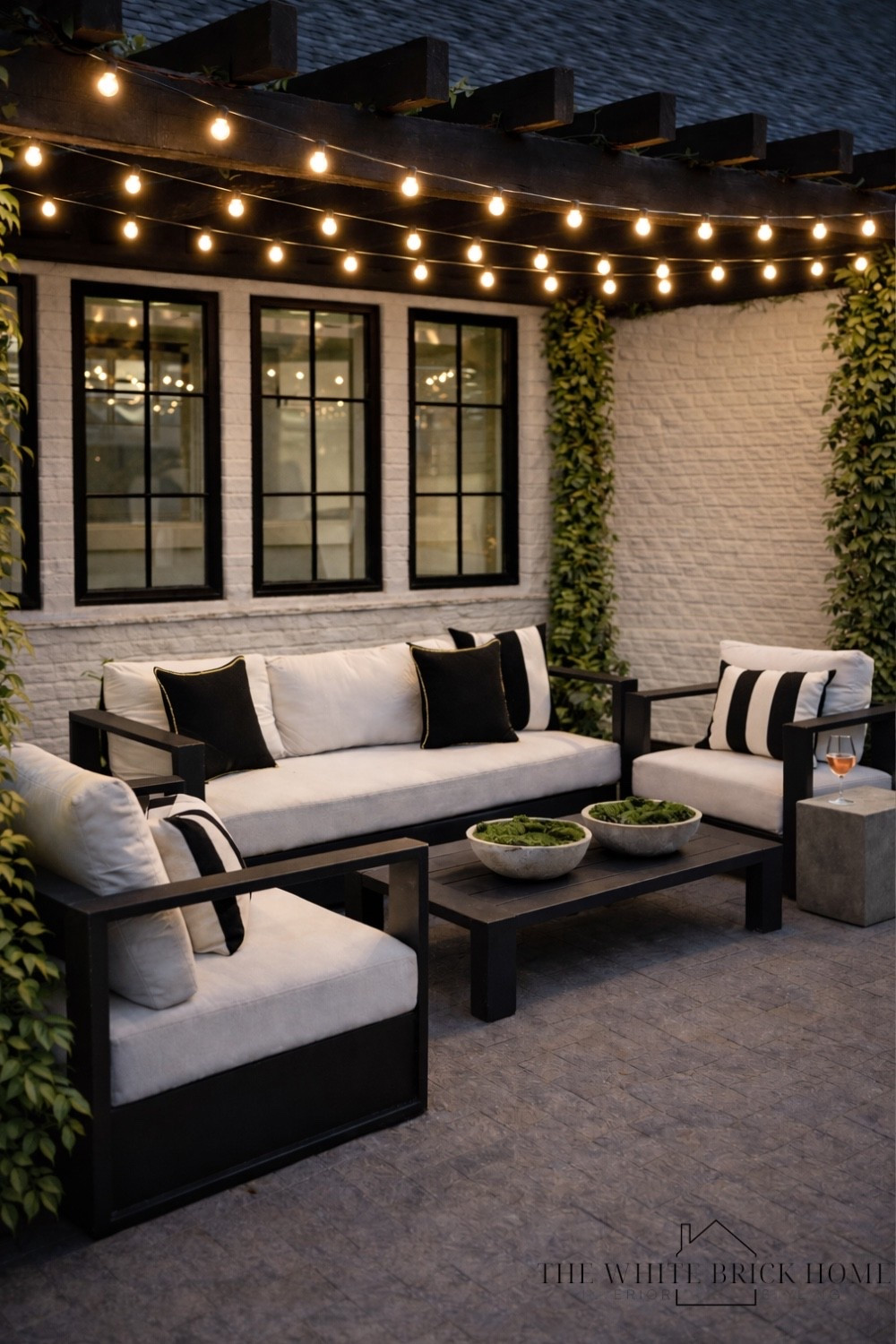 Modern traditional patio lounge with cafe lights and black pergola — the perfect cozy outdoor living space for relaxed evenings and elevated backyard entertaining.

modern traditional patio, black pergola patio, cafe lights pergola, outdoor patio lounge, cozy backyard patio ideas, black and white outdoor furniture, outdoor living room inspiration, modern patio design, pergola lighting ideas, backyard entertaining space, white brick exterior patio, stylish outdoor seating, outdoor patio styling, neutral patio decor, elegant backyard design, Amazon, Amazon home, Amazon patio furniture 

#LTKSeasonal #LTKHome #LTKSpringSale