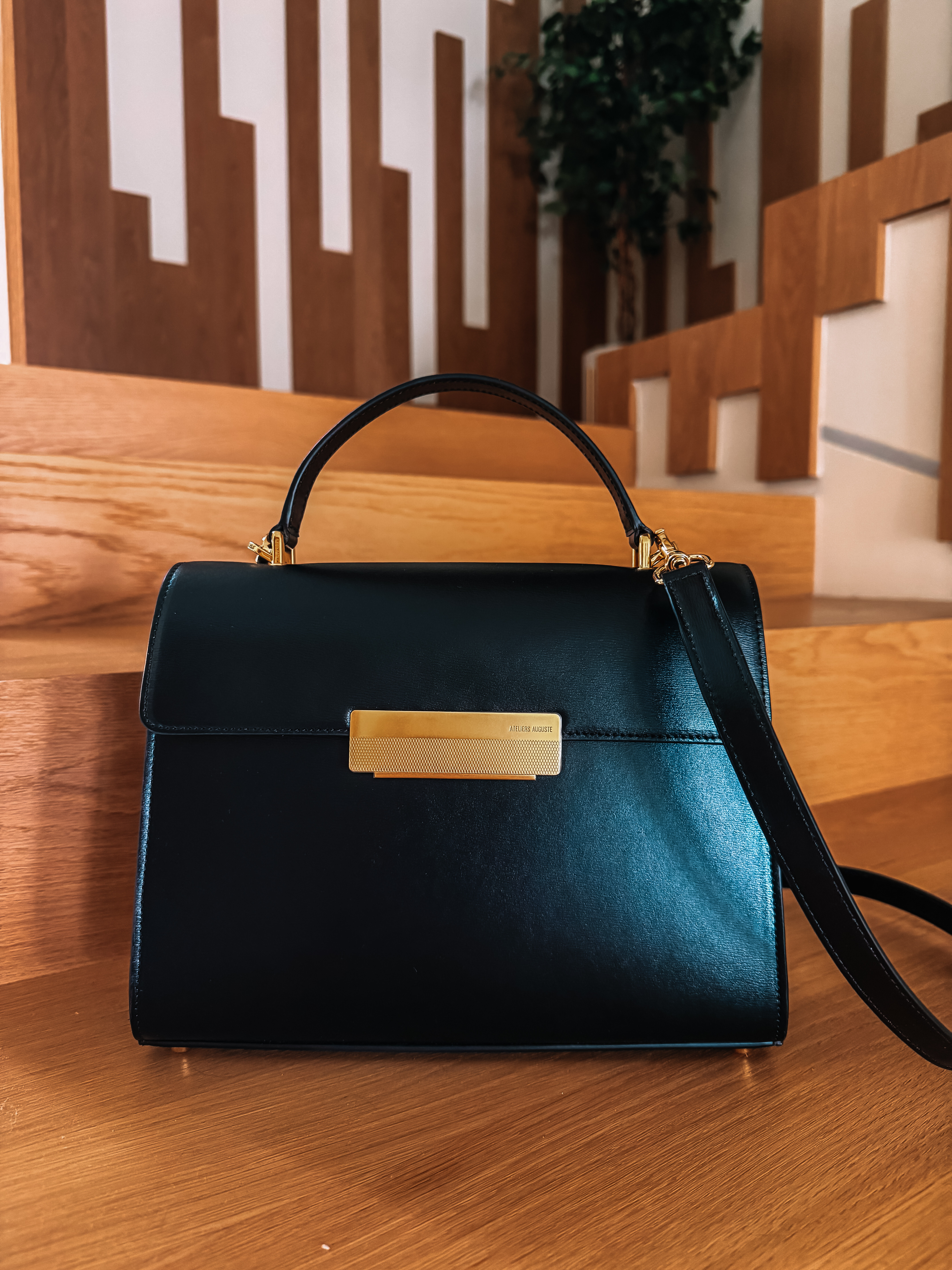 Capucines in black box leather with gold hardware. Elevated shape, the craftsmanship is top notch and that leather is a total dream. Chic Parisian aesthetic at its finest. Ateliers Auguste  

 