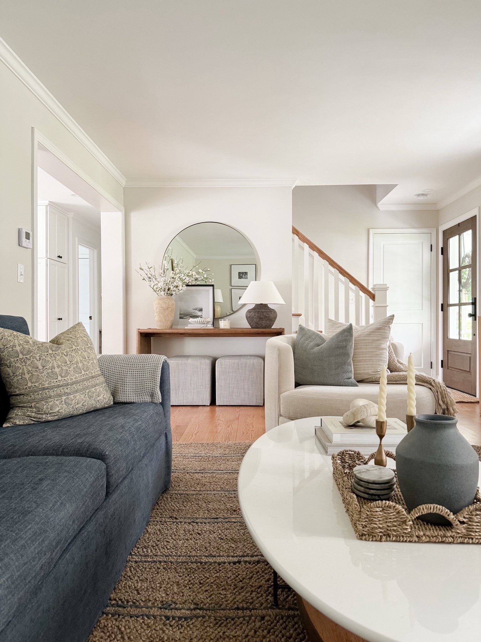 A cozy living room that has hints of spring decor 🤍 I love mixing neutrals with more vibrant colors, like shades of blue and green. Many of these picks are actually on sale right now, including our circular mirror from McGee & Co! 

#LTKSeasonal #LTKHome #LTKSaleAlert