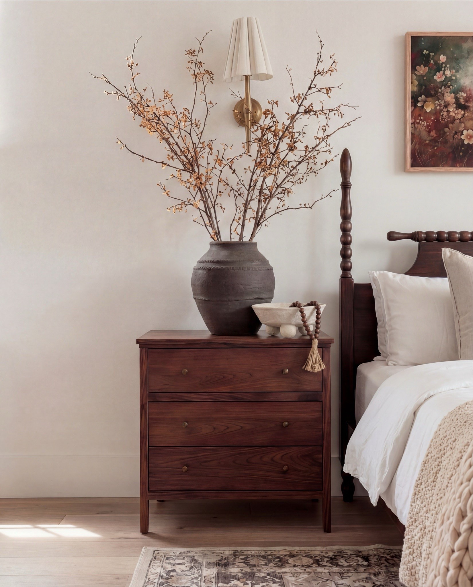 Shop the Look: Bedroom Refresh
This bedroom feels warm, grounded, and quietly romantic. The dark wood bed anchors the space with a classic, heirloom feel, while crisp white bedding and soft neutral layers keep everything light and serene. Subtle brass accents, sculptural lighting, and cozy textures add depth without overwhelming the room, creating a space that feels both timeless and lived-in.

The styling is simple and intentional—natural wood tones, soft textiles, and a mix of vintage-inspired decor that brings warmth and balance to the room.

Shop the Look:
• Dark wood spindle bed frame
• White cotton duvet cover + pillow shams
• Neutral patterned area rug
• Chunky knit throw blanket (warm beige)
• Woven knit poufs (bedside or bench seating)
• Wood nightstands with brass knobs
• Black ceramic table lamps
• White tapered lamp shades
• Brass wall sconces
• Framed floral wall art
• Textured accent throw pillows (neutral tones)
• Ceramic decorative bowl (white sculptural style)
• Wood bead garland with tassel



#LTKHome #LTKSaleAlert