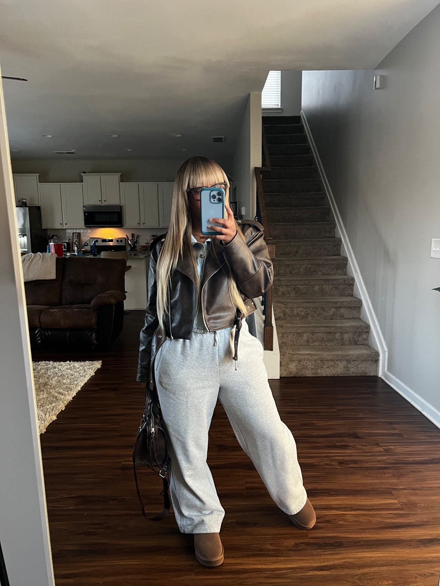 How to style a faux leather jacket with a denim button up long sleeve cropped shirt, grey wide leg sweatpants, brown faux leather purse, and brown ankle boots.

Wig: Black/Sandy blonde

#LTKootd #LTKPetite #LTKOver40