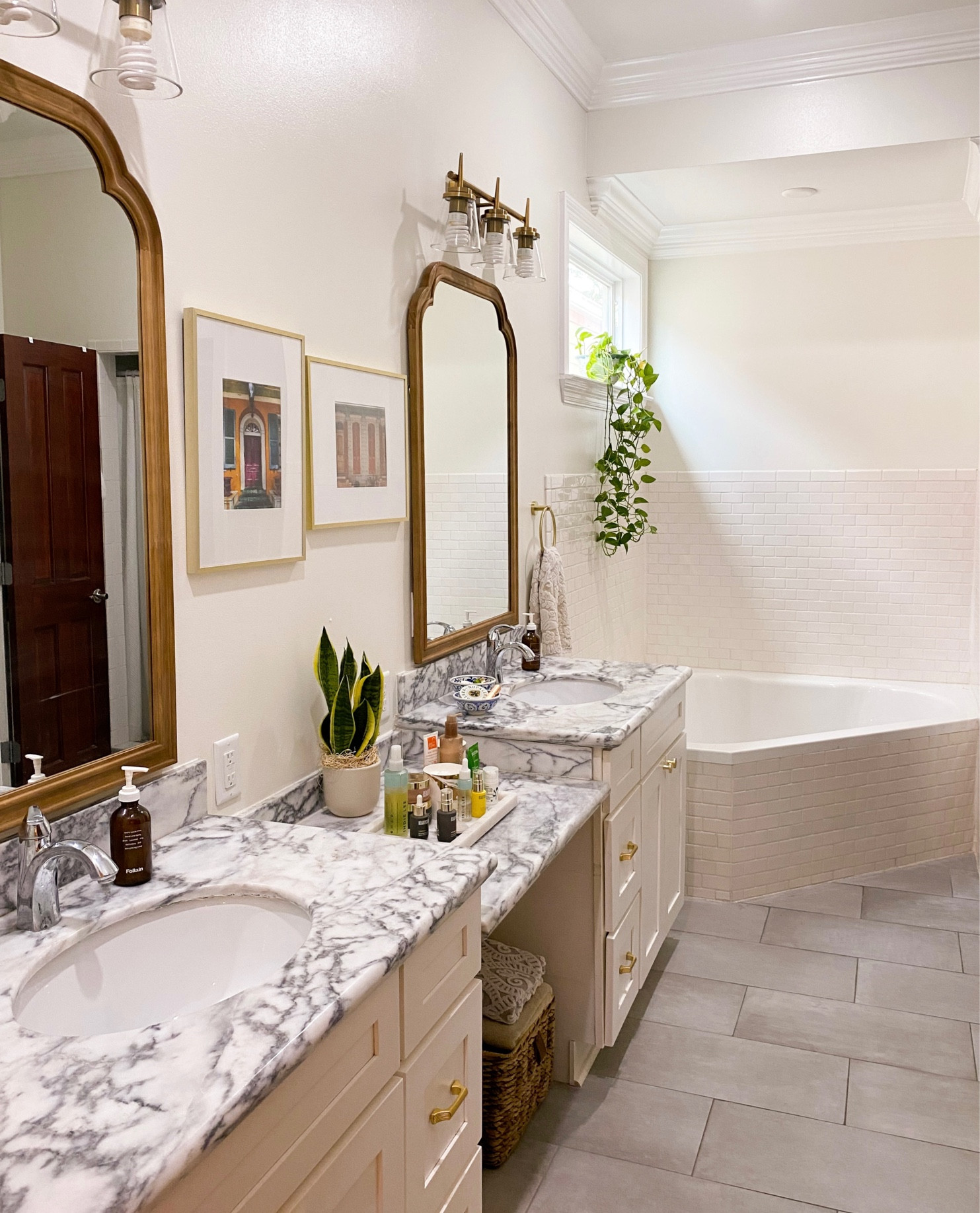 Primary bathroom makeover! Brushed gold light fixture. Brushed gold cabinet pulls. Brushed gold hardware. Marble tray. Bathroom decor. 

#LTKhome