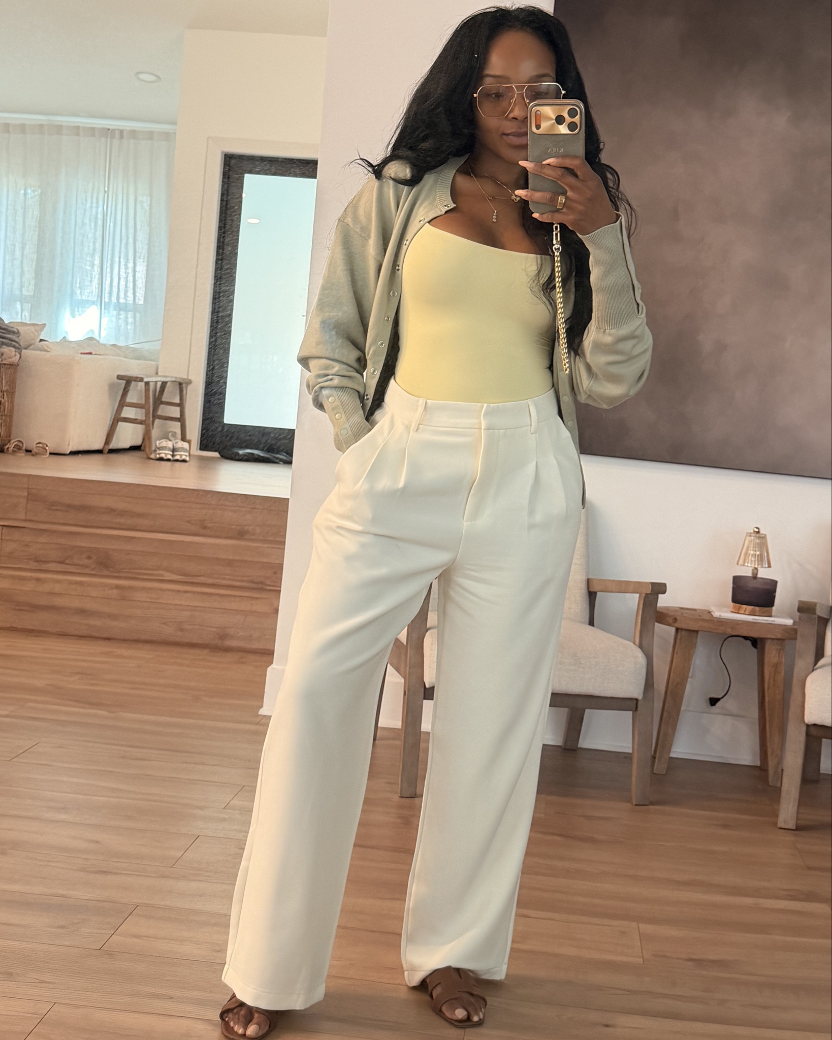 Scroll to shop this fresh neutral outfit featuring a soft sage cardigan layered over a buttery yellow tank with tailored cream trousers for a clean, elevated everyday look. The soft color palette makes this outfit feel polished, modern, and perfect for spring styling.

Perfect for casual office days, brunch, travel outfits, coffee runs, or effortless everyday style.

5'4" | 138 lbs | 34D bust | 27" waist | 40" hips