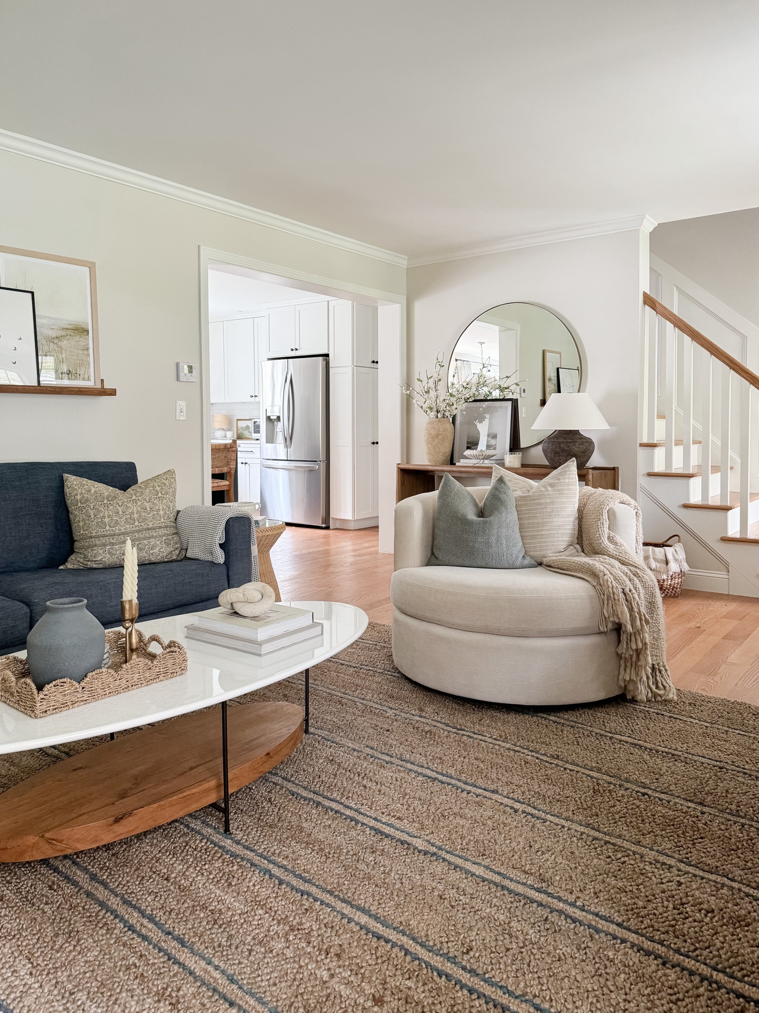 Coastal living room, Walmart home decor, coffee table, spring home decor, gallery frames, Pottery Barn rug, swivel chair, console table 

#LTKStyleTip #LTKHome #LTKFindsUnder50