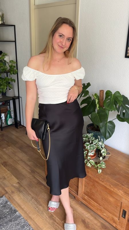 Satin midi skirt white cropped top black handbag date outfit 

#LTKbag #LTKshoes #LTKstyletip
