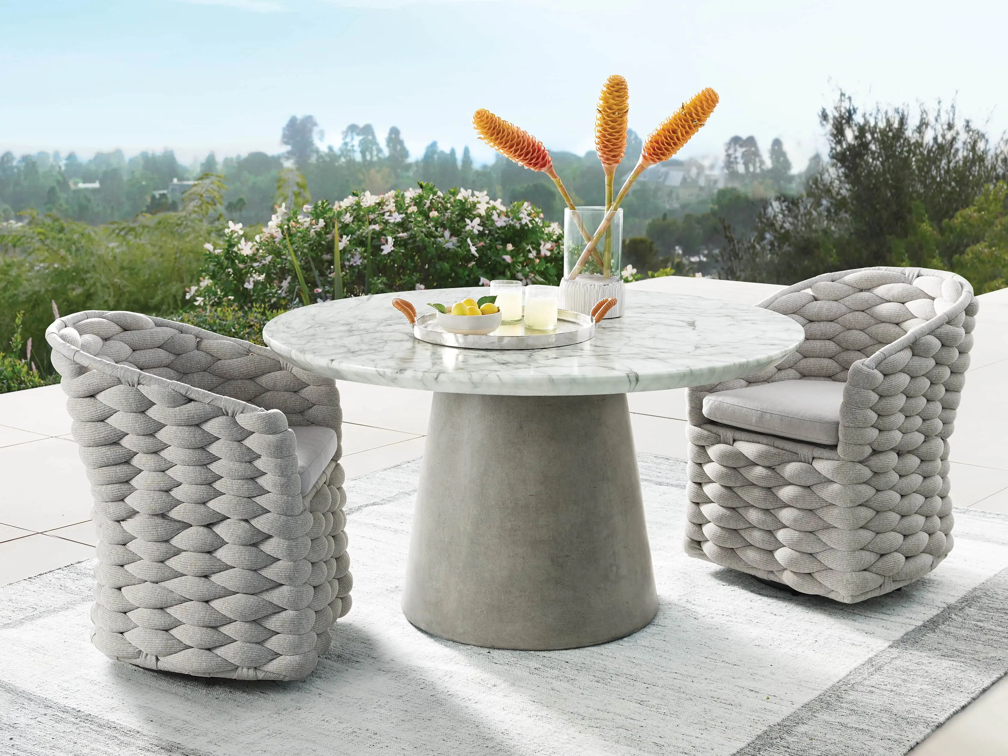 Melbourne Outdoor Swivel Dining Arm Chair in Margate Tan with Cast Silver Cushions | Arhaus