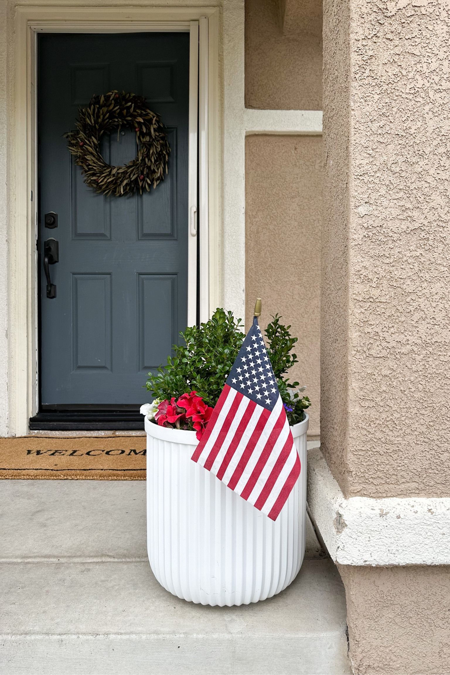 Front porch decor, 4th of July decor, American flag, welcome doormat, large white indoor/outdoor planters.

#LTKSeasonal #LTKhome