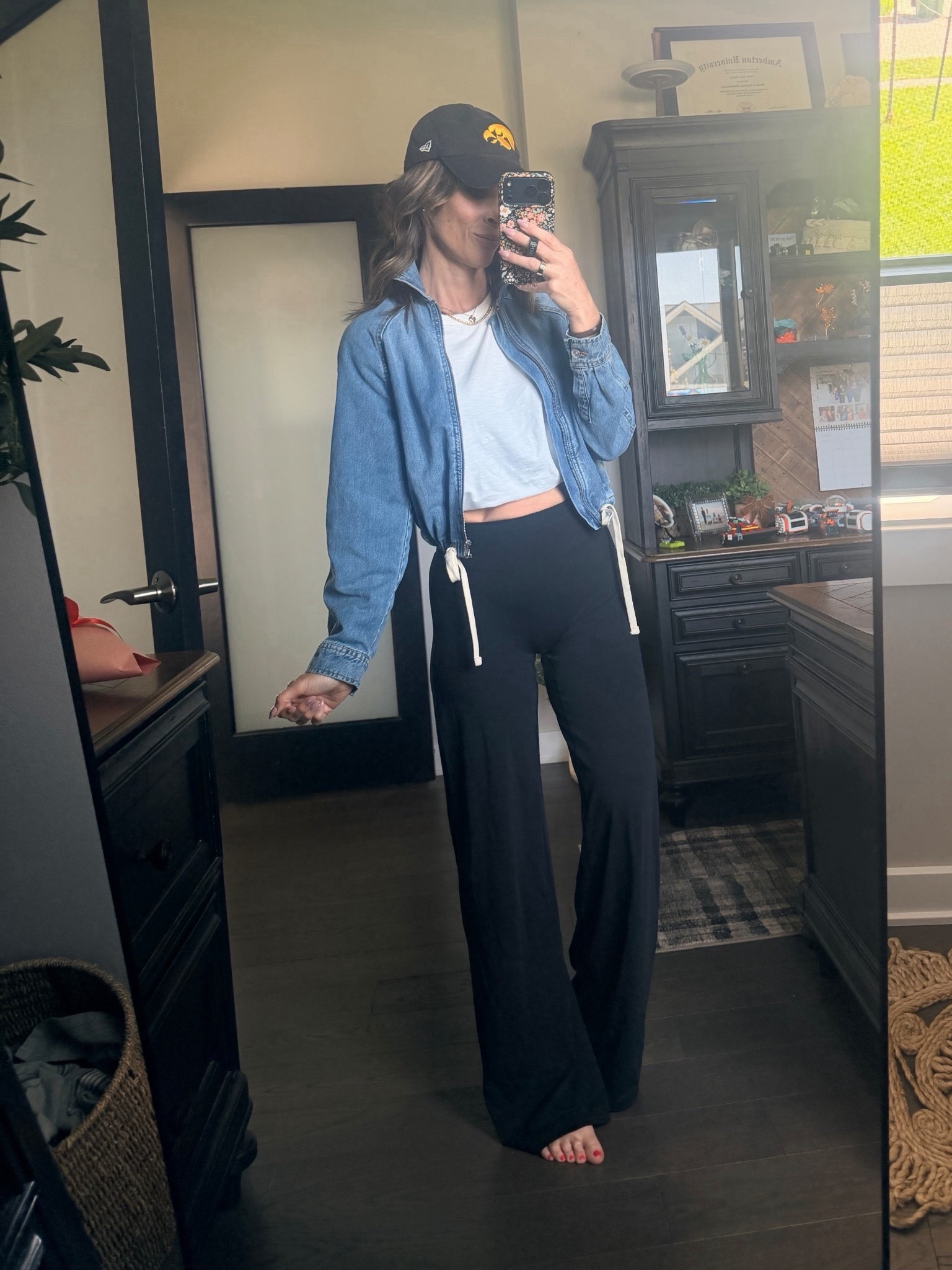 This white tea and denim jacket look just like Madewell, but for a fraction of the cost! The black highway is wild leg hands fit just like leggings on top, but have a straight wide leg fit all the way down. This is such an easy outfit for a mom on the go that also looks put together for a baseball game. Just swap out your hat for your kids team!

#LTKxMadewell #LTKOver40 #LTKSeasonal