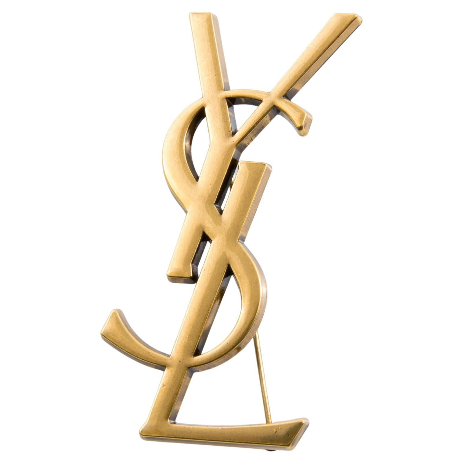 Yves Saint Laurent Gold-tone large YSL Cassandre Brooch | 1stDibs