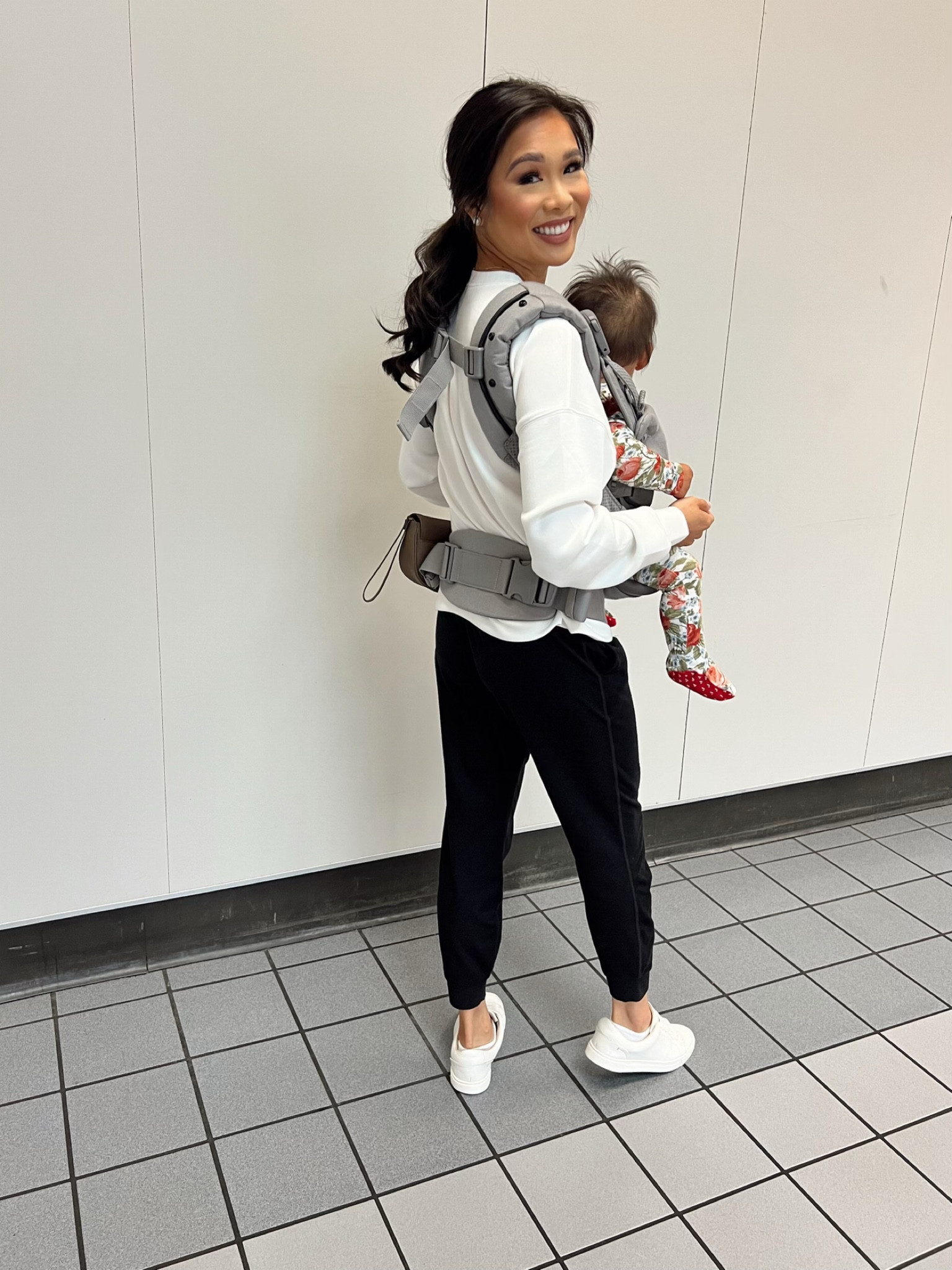 Travel day with baby girl! Using a carrier in the airport has made it so much easier. Wearing black performance joggers in XS paired with white crewneck in XS and my leather sneakers for a comfy look  

#LTKBaby #LTKStyleTip #LTKTravel