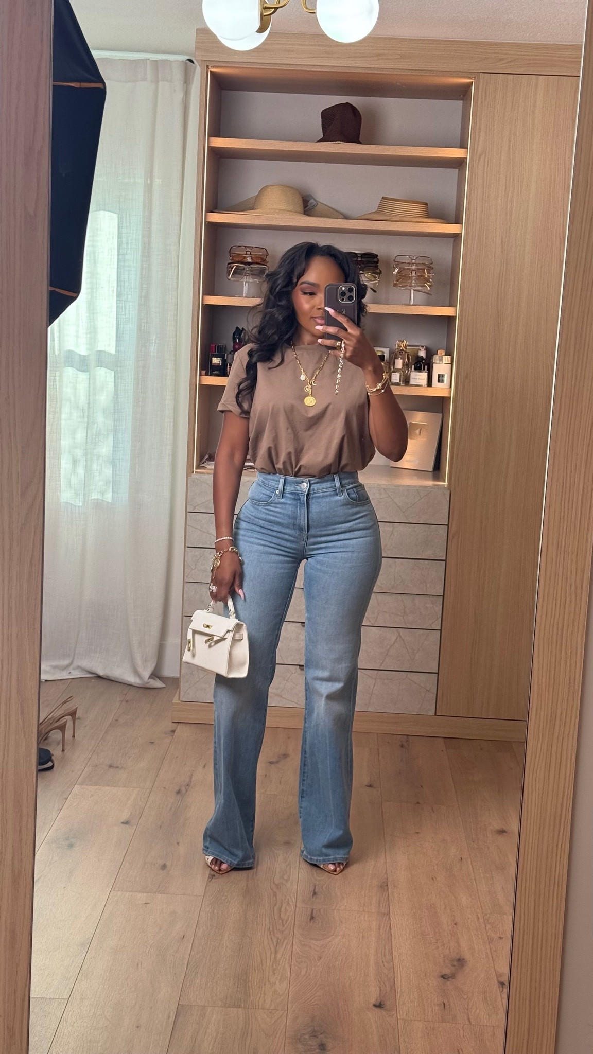 Hi babes! 🤎

Okay this neutral tee + perfect denim combo is EXACTLY the kind of outfit that always performs because it’s effortless, flattering, and insanely wearable. The warm mocha tone paired with this dark wash flare denim gives that elevated everyday vibe without trying too hard.

A good fitted tee and great jeans will forever be one of the smartest wardrobe investments because you can style them a million different ways. Added layered gold jewelry + a structured mini bag to give it that luxury-inspired feel while still keeping the look casual and easy.

Where to wear this:
• Coffee runs
• Casual office days
• Lunch dates
• Everyday errands
• Weekend shopping
• Casual dinner nights

This is one of those outfits where the cost per wear drops FAST because every piece works with so many staples already in your closet. Simple outfits styled well always look the most expensive.

Everything is linked below ✨

xx Kira | IG: KirasFashionFinds

5’4 | 140LBS | 34D-27-40 | size small | jeans 27