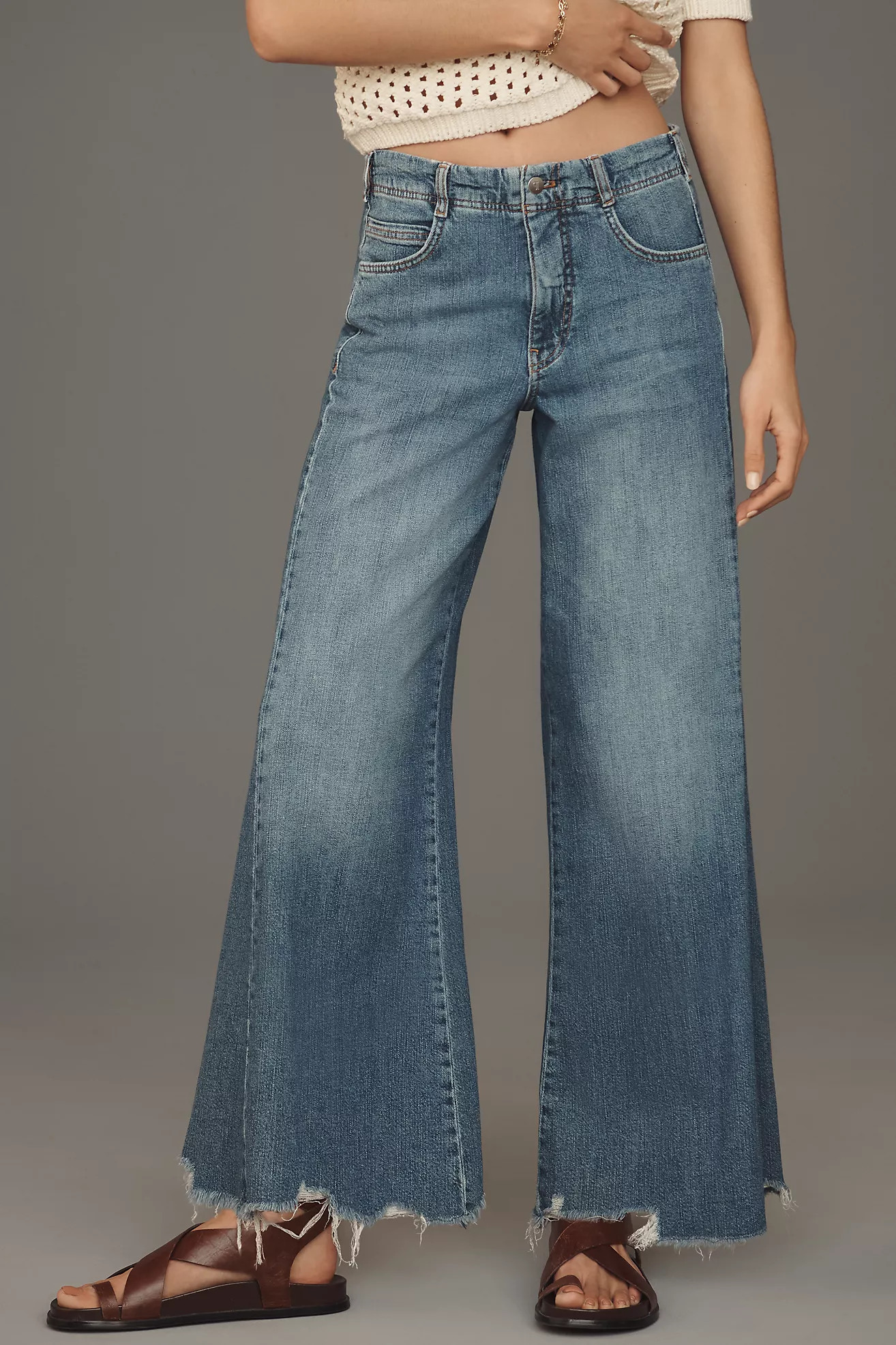 The Adi Regenerative Cotton Mid-Rise Frayed Relaxed Flare Jeans by Pilcro | Anthropologie (US)