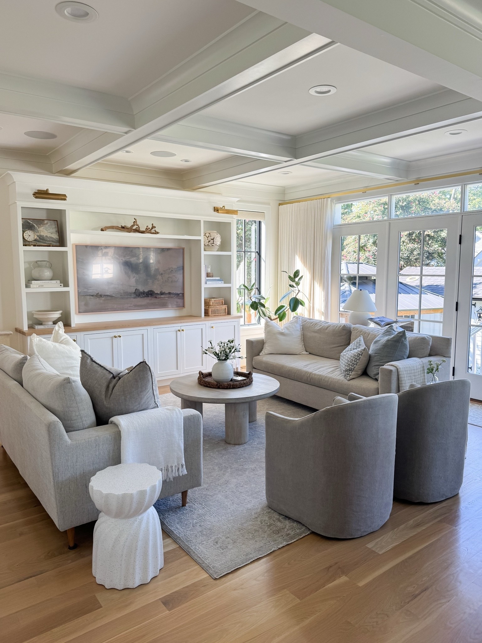 The room where everyone ends up 🤍 Layered neutrals, warm wood, soft blue-gray accents and plenty of comfortable seating make our great room feel collected and cozy while still standing up to everyday family life. A few favorites—the swivel chairs, round coffee table, washable rug, Frame TV and the built-ins that completely transformed this space. Everything is linked!

#LTKHome #LTKSaleAlert #LTKdayinmylife