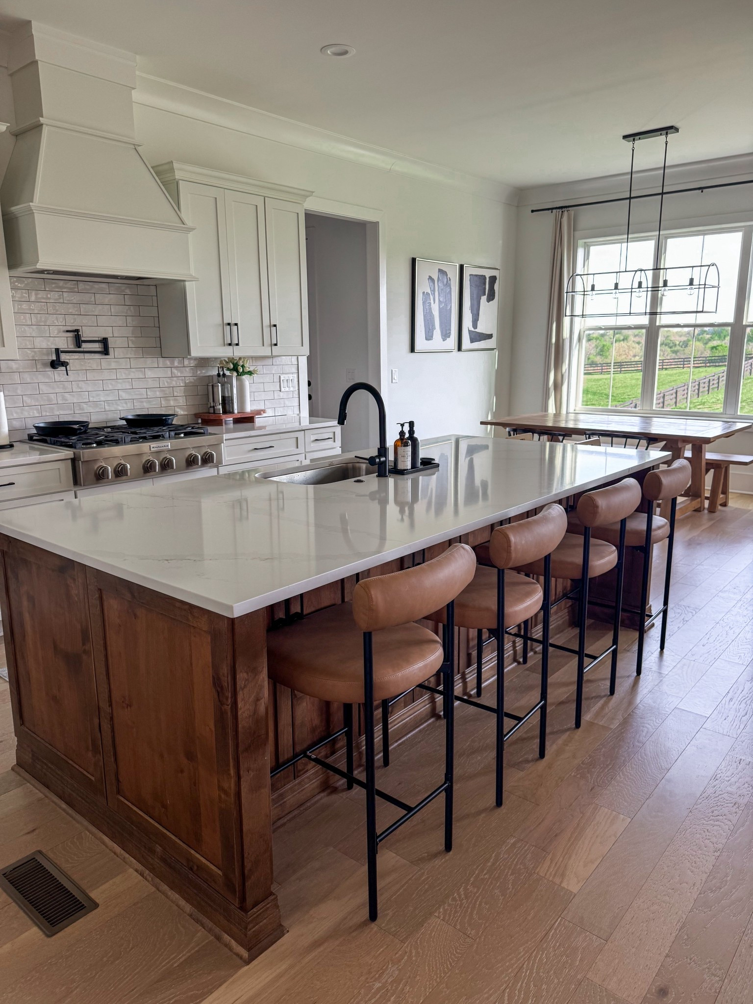 Kitchen Counter Bar Stools | Leather + Black Metal Nathan James Island Barstool Mid-Century | Natural Wooden Modern Farmhouse Dining Table with black barrel chairs  #barstool #kitchenseating #kitchentable #diningtable

#LTKHome