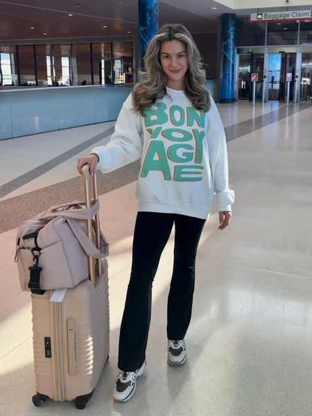 Bon Voyage rhinestoned crew neck sweatshirt, flare Hugh waisted leggings, chunky sneakers, and the perfect trendy carry on luggage for todays travel look 

#LTKtravel #LTKfit #LTKshoecrush