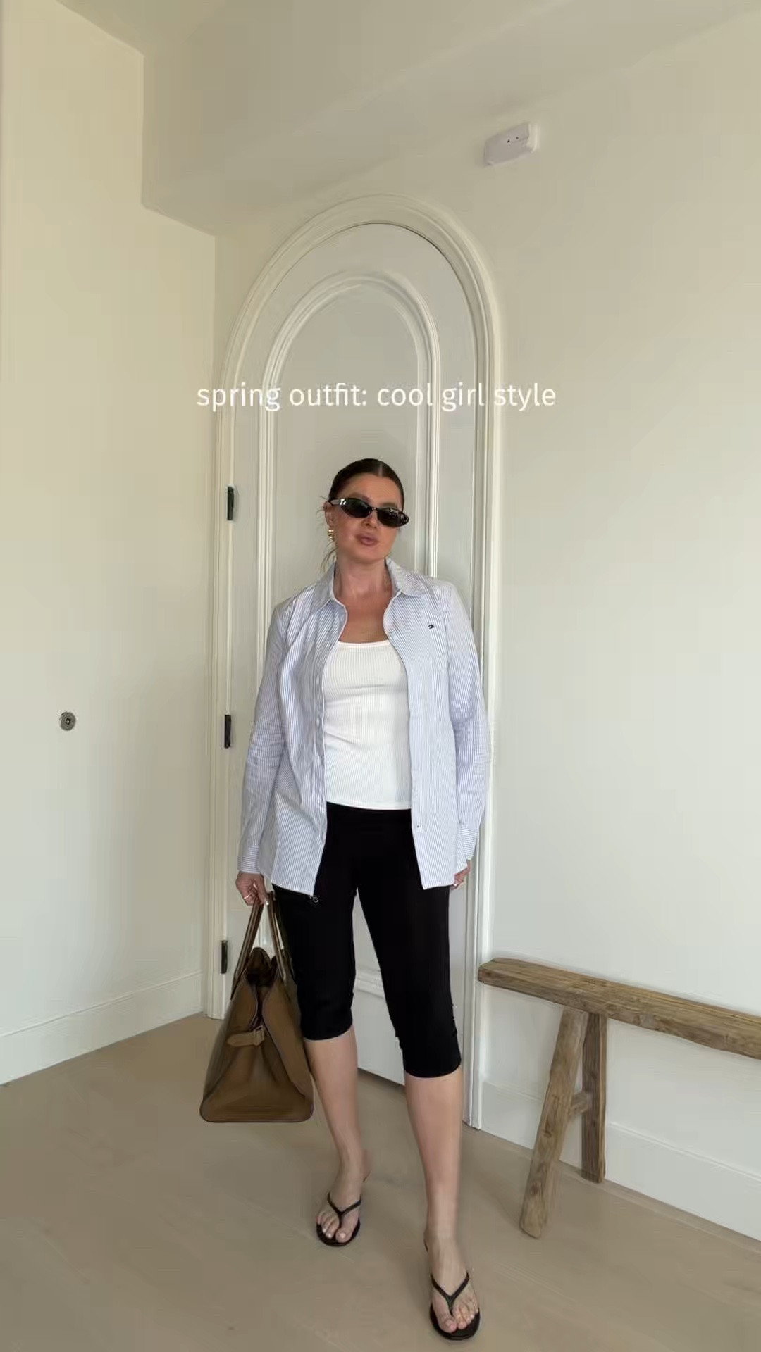 Styling capri pants with a while tank, blue striped @tommy shirt, sandals, sunnies and a chic Margaux tote. A perfect casual outfit for spring or summer days. The shirt is a regular fit, wearing size S. Size up if you want an oversized fit. 
#capri #buttondown #springoutfits #summeroutfits

#LTKootd #LTKgrwm #LTKSeasonal