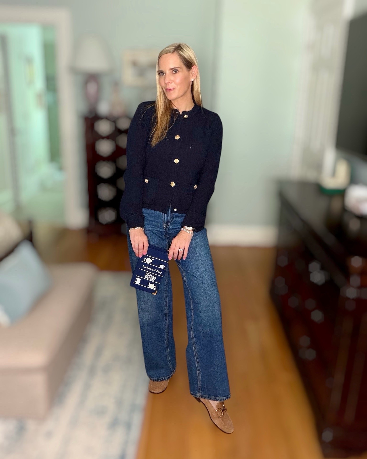 Old Money Cardigan + Book Lover Bag 📚💙

The cardigan that looks so much more expensive than its price tag! ✨ This navy knit cardigan with gold buttons is giving classic old-money style and is such an easy piece to dress up or down. I paired it with wide-leg denim, loafers, and the cutest book-inspired crossbody for a polished look that’s perfect for work, brunch, library days, or coffee dates. 🤍

The cardigan has a soft, stretchy knit with functional pockets and beautiful gold button details that elevate the entire outfit. My “Booked & Busy” handbag is the perfect conversation starter for fellow book lovers! 📖☕️

Classic style never goes out of fashion, and these timeless pieces will be staples in your wardrobe for years to come. ✨

Classic style, old money aesthetic, quiet luxury, navy cardigan, gold button sweater, preppy fashion, work outfit inspiration, teacher outfit, business casual, wide-leg jeans, loafers, book lover accessories, book clutch, fall fashion, timeless wardrobe, elevated basics, everyday chic, capsule wardrobe. ✨

#LTKOver40 #LTKSeasonal #LTKootd