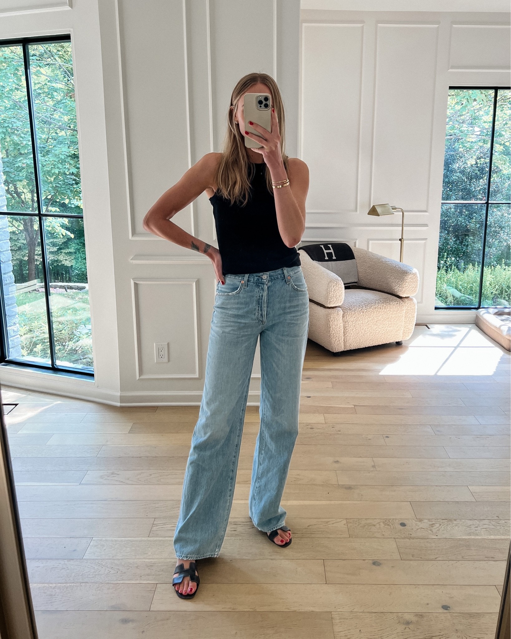 Fashion Jackson wearing black tank, COH jeans, Hermes sandals #jeans 

#LTKstyletip #LTKshoecrush