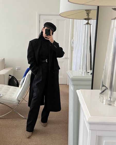 Donna Bartoli of donnabartoli.com wears a stylish winter look. Nautical cap, oversize black wool coat, long sleeve wool knit top, tapered black trousers, pointed heeled boots. Exacr trousers and top are listed, similar items for everything else

#LTKeurope #LTKSeasonal #LTKfit
