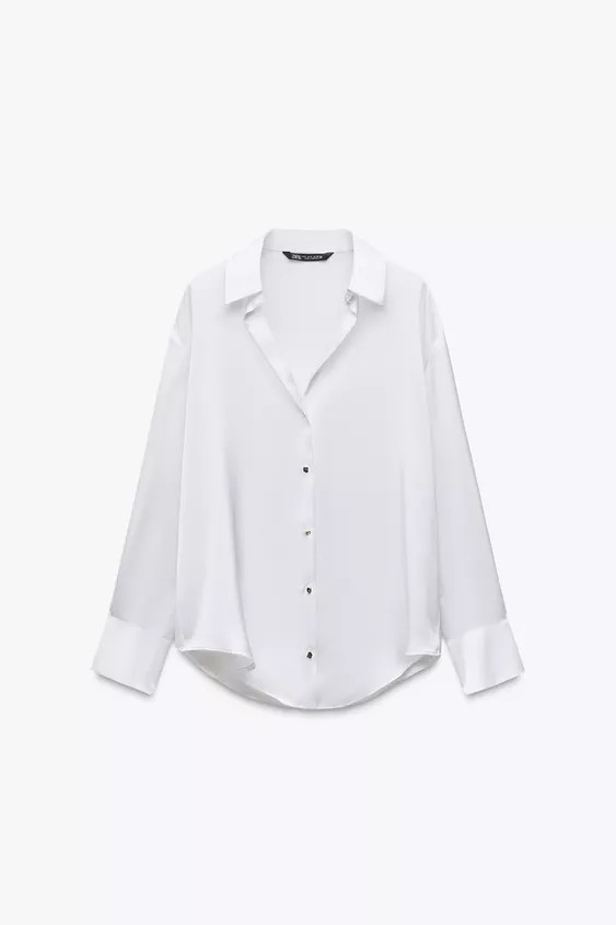 Flowing long sleeve shirt featuring a lapel collar, V-neckline and front fastening with golden bu... | Zara US