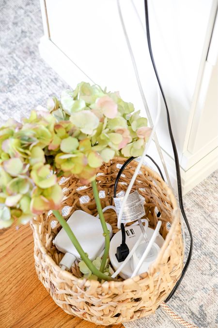 A creative way to hide unsightly cord connections is to put them on an open-weave basket with flowers in it. I use this in my office where my desk is in the center of the room.

#LTKhome