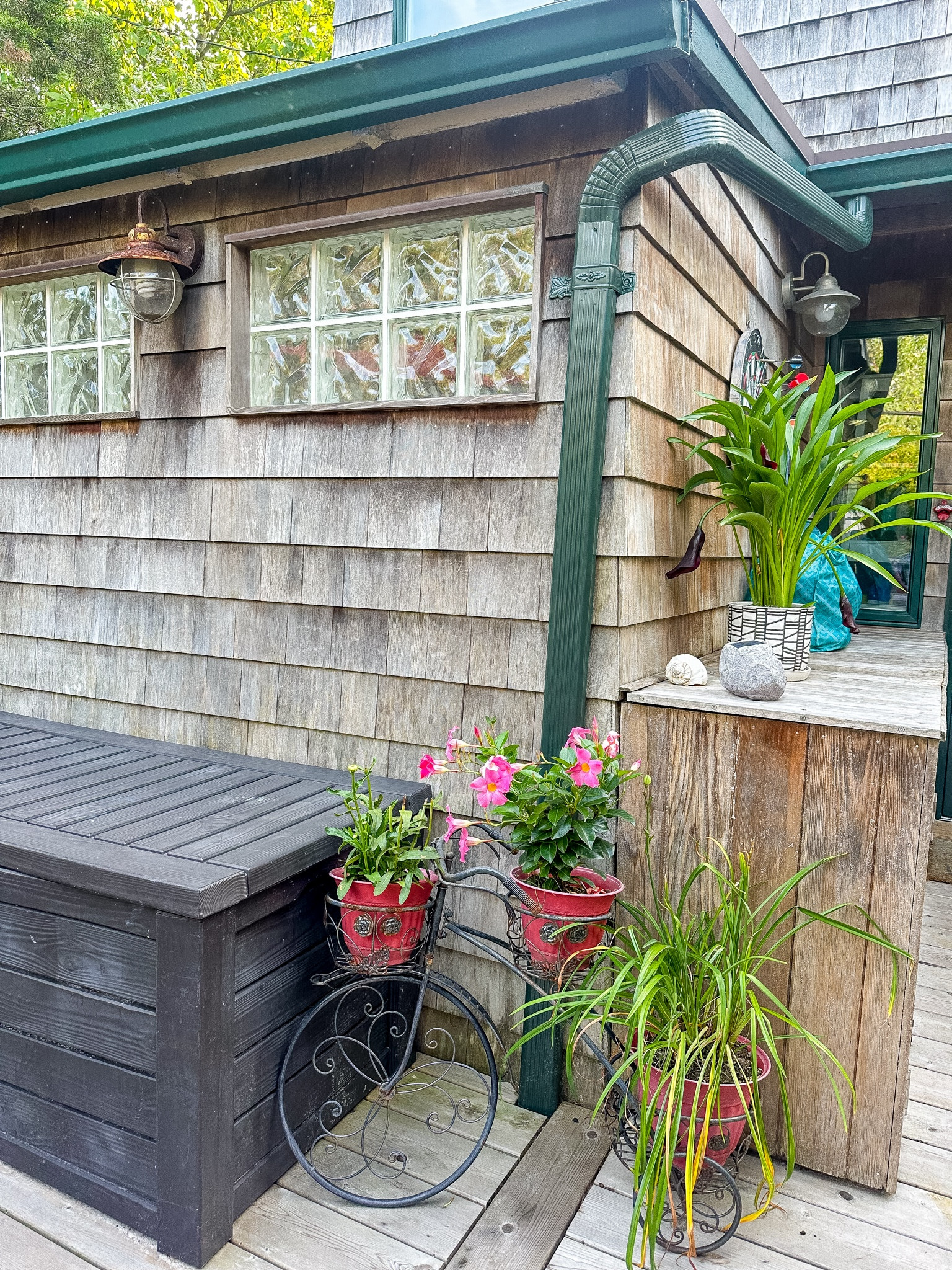 An outdoor oasis. During the summer I live outside and I am always looking for the perfect decor. A cute outdoor bench to house storage and I love these iron trellis bicycles which hold all the greenery. 
Off to the side is an outside dartboard which is always fun when hosting parties. 

#LTKSeasonal #LTKFamily #LTKHome