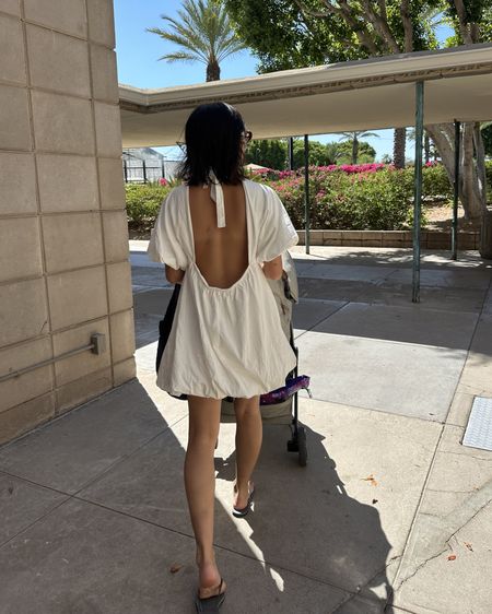 Wearing XS! Wore this as a pool cover up and the open back was so nice! I felt so chic yet comfort bc the material is like a cotton t shirt 🤍

Cute summer dress beach outfit white mini dress and sandals havaianas outfit