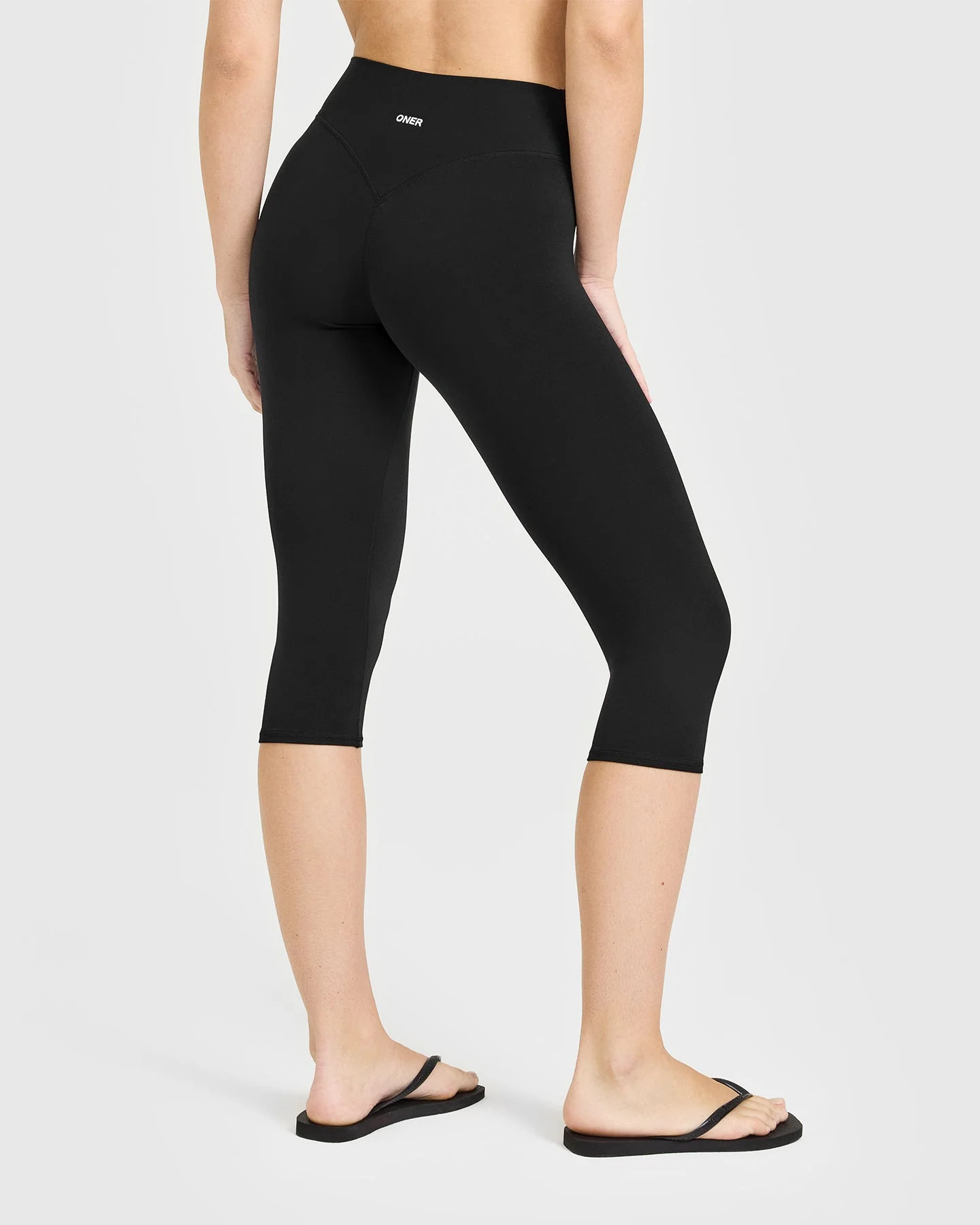 SoftMotion™ High Waisted Capri Leggings with White Logo 
 Black | Oner Active (UK / US)