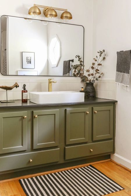 For under $500, I was able to transform my kiddos dated AF bathroom. In addition to building DIY countertops and painting the vanity in Benjamin Moore’s Dark Olive, I modernized the space with budget-friendly decor which you can shop here!  #homedecor #diy #bathroomdecor #bathroom #vanity #sink #mirror #budgetdecor 

#LTKSaleAlert #LTKFindsUnder100 #LTKHome