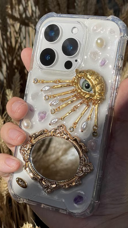 This aesthetic evil eye phone case features a vintage gold mirror, pearl embellishments, and luxe charm details for a stylish yet functional look. Perfect for trendy phone accessories lovers, gift ideas, and elevated everyday essentials. Ideal for -viral aesthetic finds, fashion accessories, and chic tech accessories.

aesthetic phone case, evil eye phone case, mirror phone case, pearl phone case, luxury phone accessories, trendy phone case aesthetic, viral Pinterest phone case, chic tech accessories, fashion phone accessories, gift ideas for her, stylish phone case

#LTKHome
