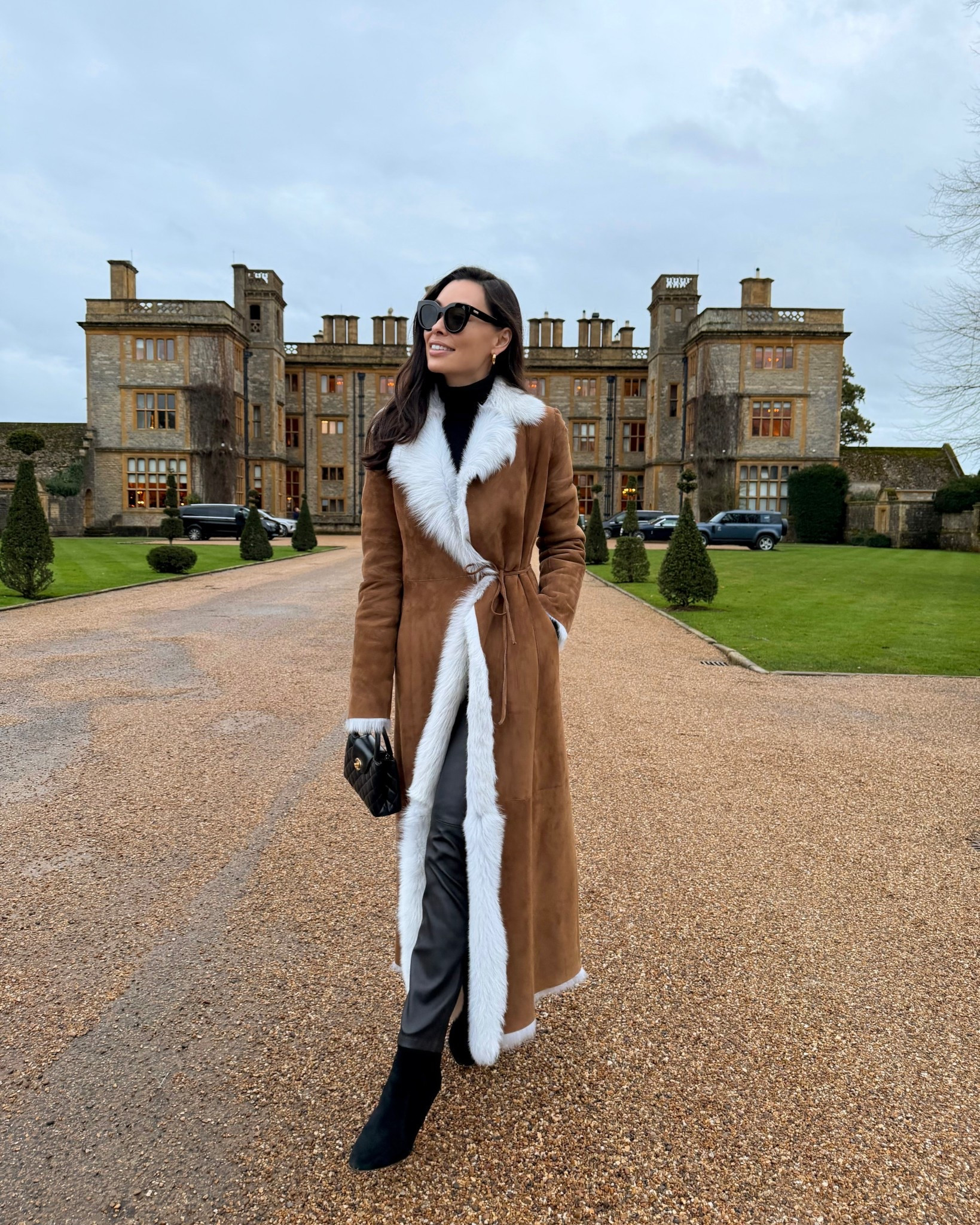 Shearling coat, brown suede coat, winter outfit, Kat Jamieson style, leather pants, black booties, Estelle Manor, English countryside. 

#LTKTravel #LTKHoliday #LTKootd