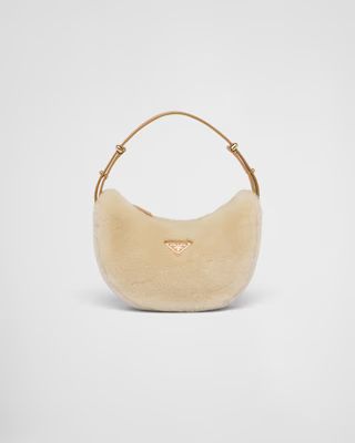 Prada Arqué shearling and leather shoulder bag | Prada Spa US