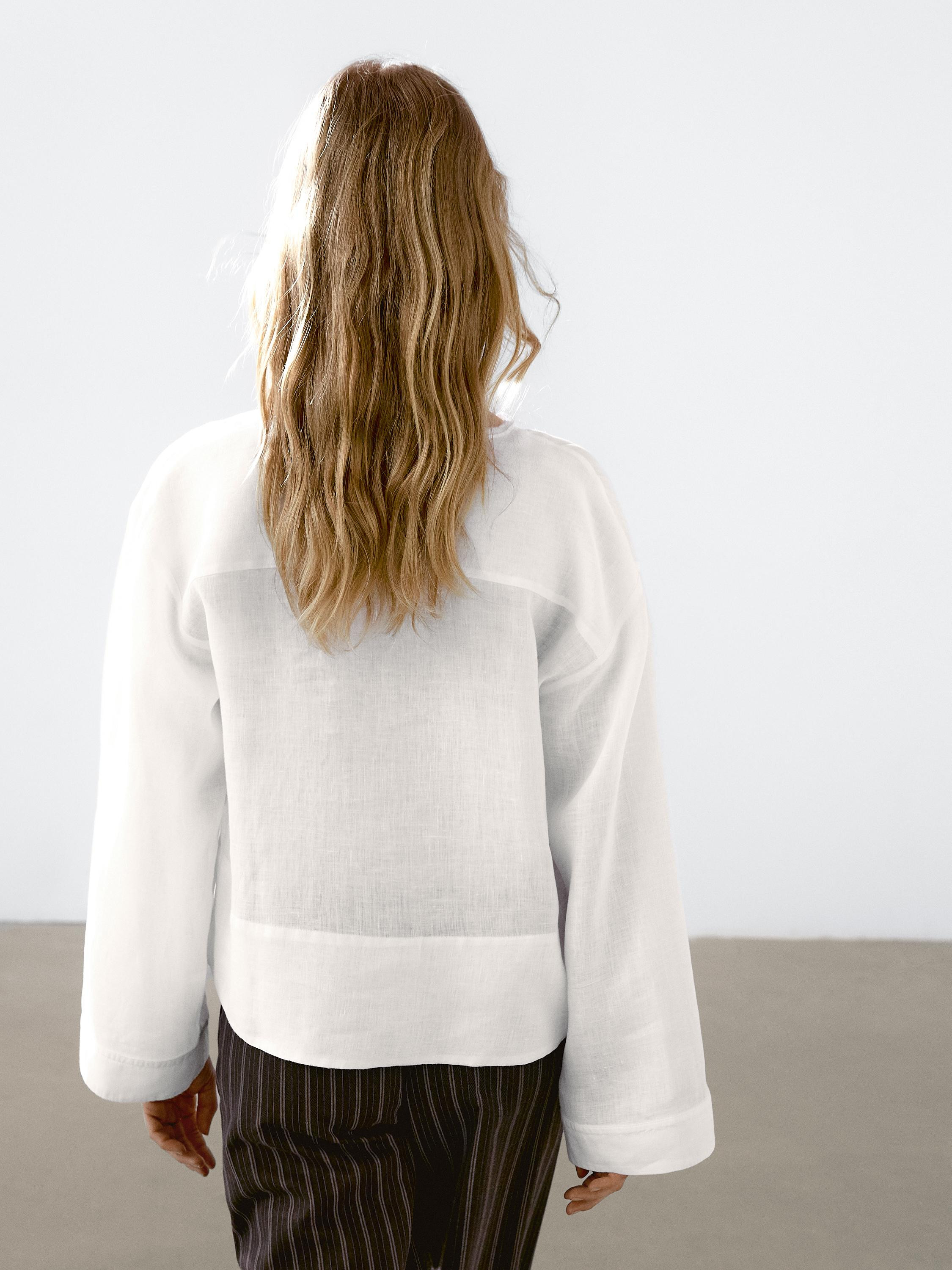 Shirt made of 100% linen. Stand-up collar with V-neck. Long sleeves. Flowing fabric. Wide and rel... | Massimo Dutti UK