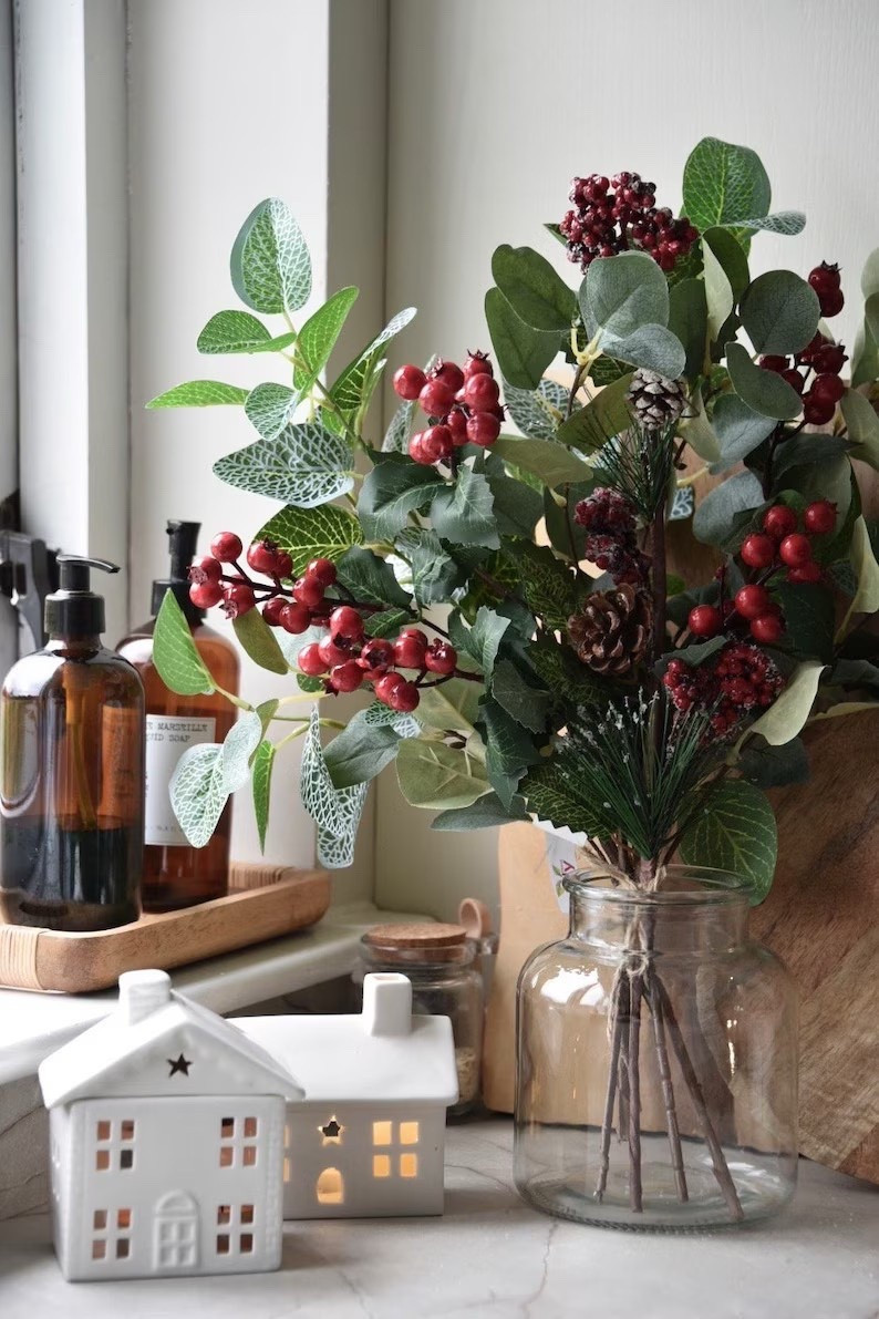 Bring the cozy magic of winter indoors with this beautifully crafted faux red berry arrangement from CharlotteSmythArt. The lifelike mix of vibrant berries, frosted pine cones, and textured greenery adds a warm, natural touch to your seasonal décor—perfect for mantels, centerpieces, or gifting. Each piece is handmade in Northern Ireland and wired for easy styling, giving you long-lasting beauty without any maintenance. A simple vase is all you need to let this timeless winter bouquet shine. ✨🍒🌿
#LTKhome #etsygifts #winterdecor #holidayhomedecor #fauxflowers #christmasstyle #redberryarrangement #rusticwinterdecor

#LTKHome #LTKHoliday #LTKSeasonal