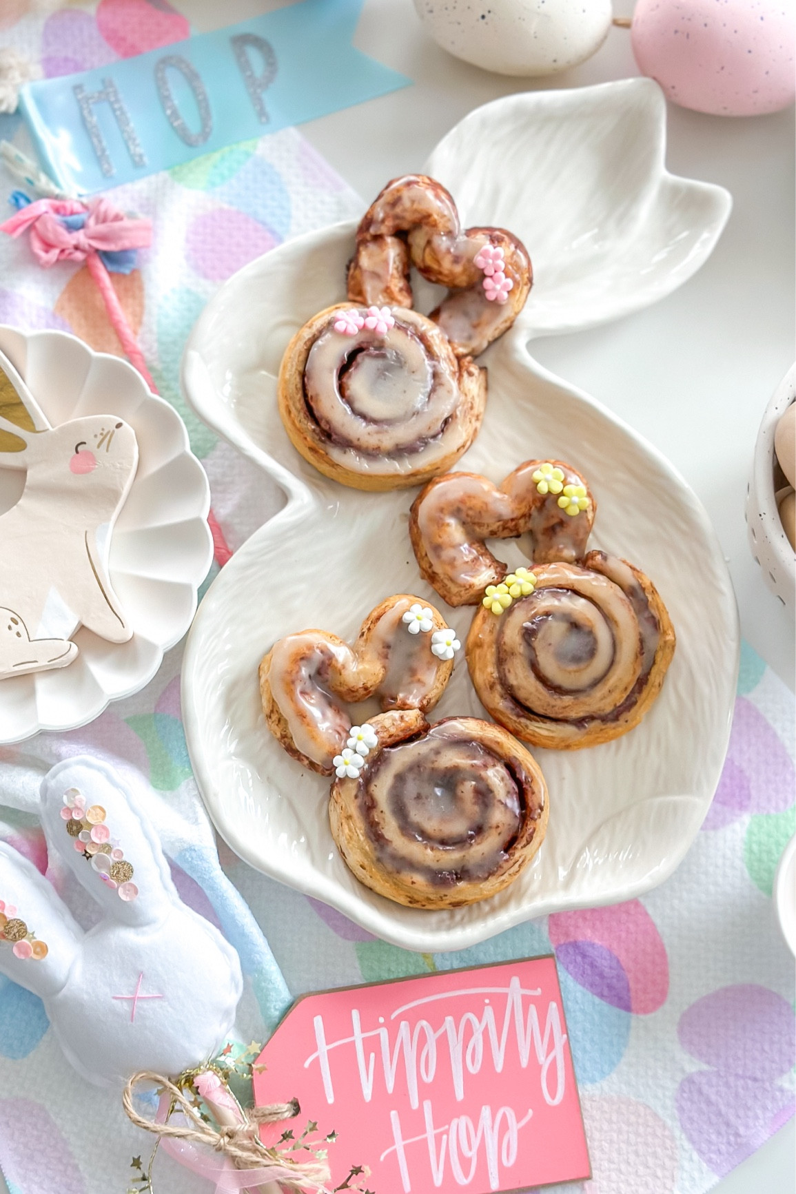 Cinnabunnies for Easter 

Preheat your oven to 350°F. 

Line two large baking trays with parchment paper.

Remove the cinnamon swirl dough from the packaging. Place 6 of them between the two trays.

Taking one of the remaining rolls, unroll the swirl and cut in half so you have two longer pieces. Shape these into 2 large horseshoe shapes to form the ears. Pinch the ends together and press these into the top of the cinnamon roll so that they are touching. Repeat with the remaining dough.

Bake for 11-14 mins, until risen and golden brown. Meanwhile, make the icing as included in the cinnamon swirl pack instructions.

Once the rolls have cooled slightly, drizzle the icing and adorn with sugar flower decoration.  

#easter #easter2024 #family #home #baking #party #holiday 

#LTKSeasonal #LTKfamily #LTKfindsunder50