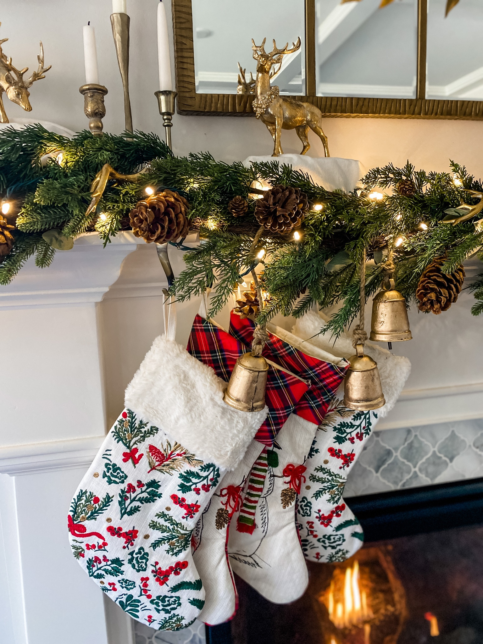 Christmas holiday fireplace mantle decor lights garland bells stockings deer candle holders!

#LTKSeasonal #LTKHoliday #LTKhome