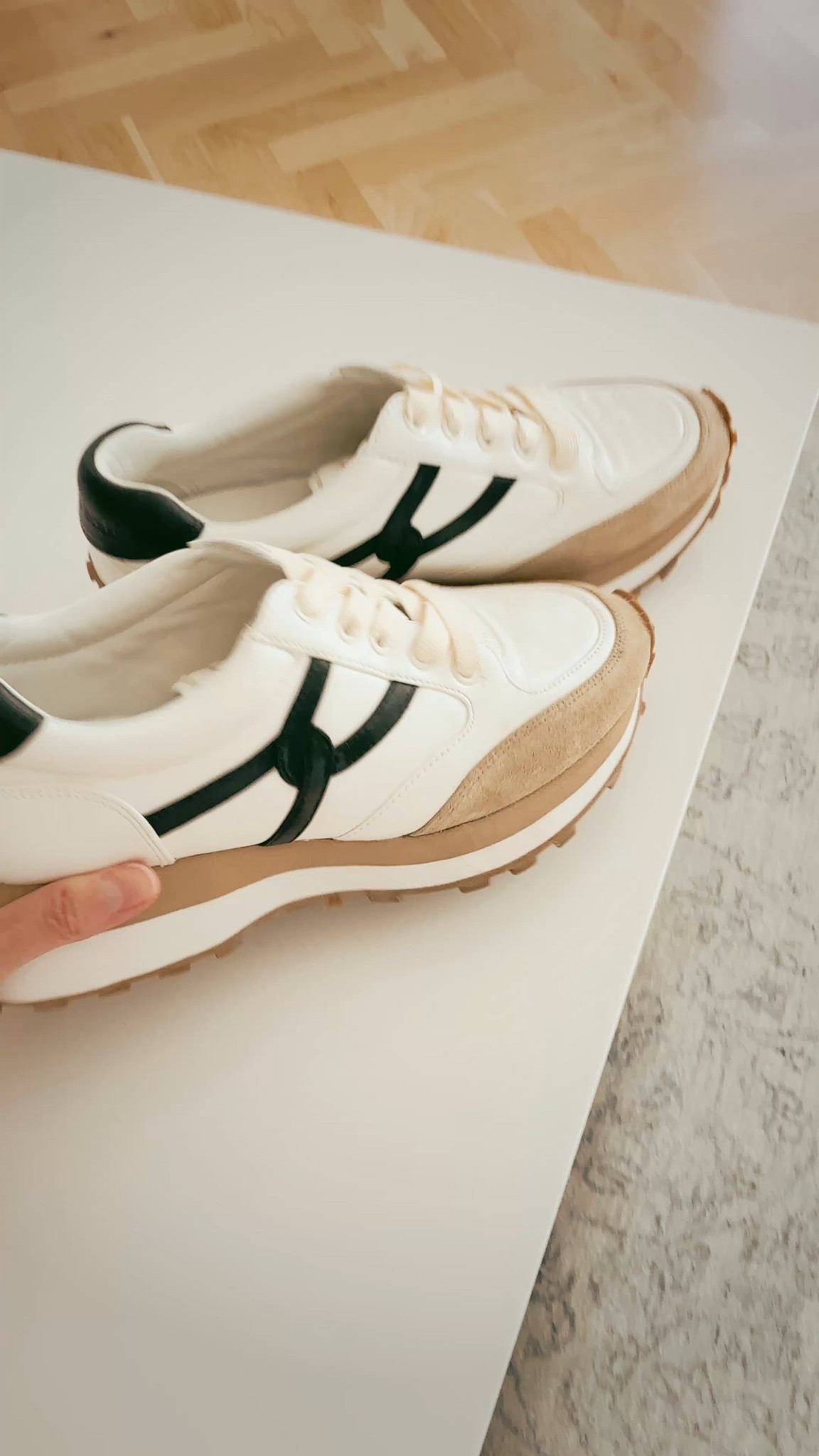 BUSBEE best-selling sneakers. These are slip-on, slip-off (no lacing needed). They have a small platform for added height and comfort. And they are very chic for everyday wear. I love to wear mine on travel days. They run true to size.