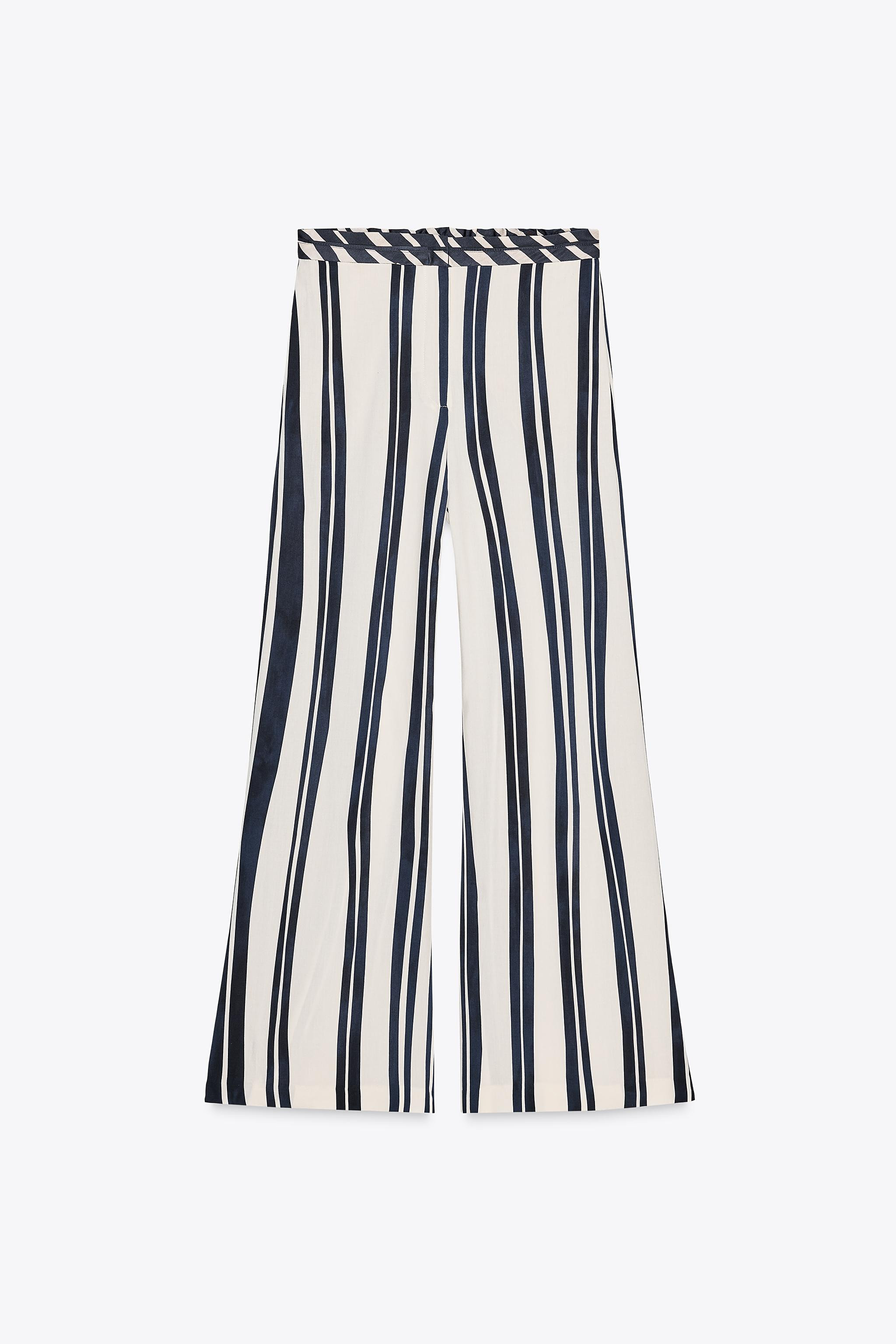 ZARA WOMAN COLLECTIONMid-waist trousers made of viscose. Side pockets concealed in the seam. Wide... | Zara UK