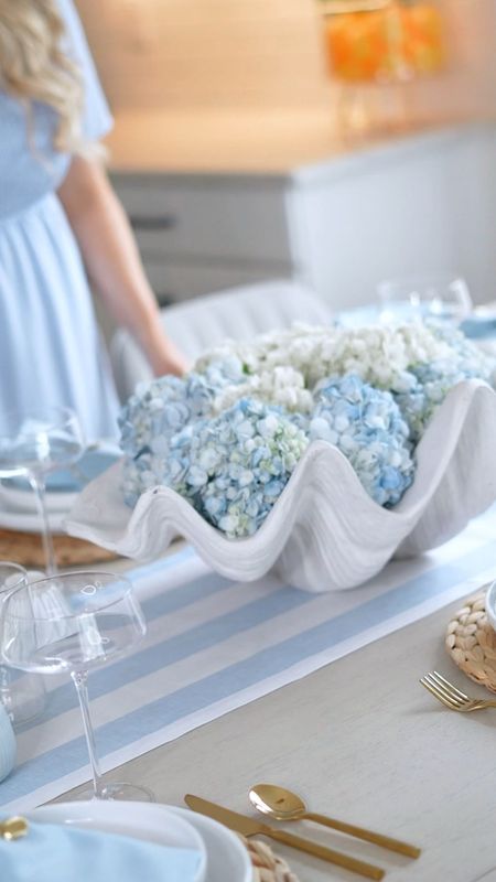 Coastal tablescape 🌊 Blue and white decor with wicker placemats and gold silverware! The Shell vase and shell napkin holders are my favorite🐚 

#coastaltablescape #beachtablescape #blueandwhitedecor #coastaldecor #beachdecor #summerdecor 

Beach decor • coastal style • shell decor • blue and white • summer style • summer decor •beach house decor • coastal tablescape


#LTKHome #LTKFindsUnder50 #LTKSeasonal