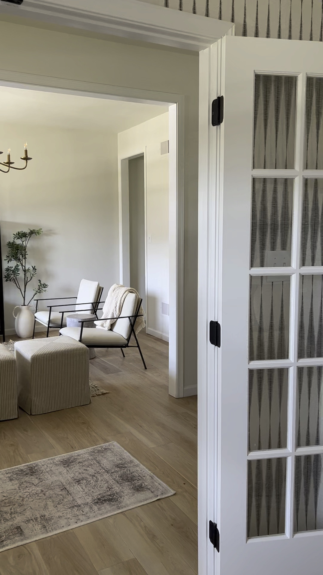 Neutral home, sitting room, ottomans, loveseat, glass and metal cabinet, woven rug, jute rug, two pages curtains, drapes, pleated drapes, antelope pillow, accent chairs, brass chandelier, Potterybarn, West Elm, Amazon, Target, side table, living room, neutral decor

#LTKhome