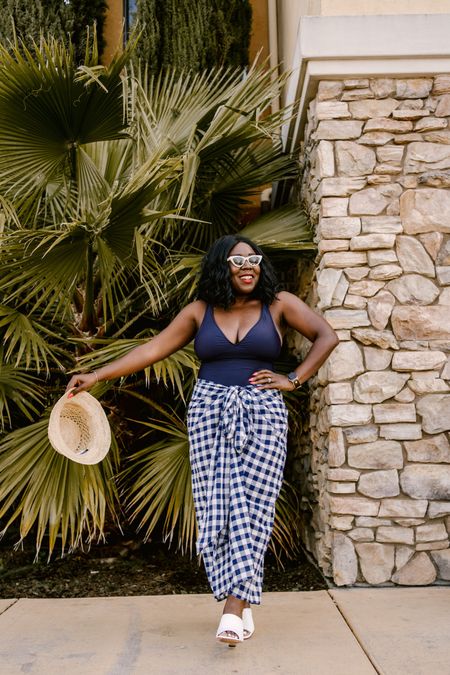 Beach ready!! I feel so classy in this look from J.Crew! Navy one piece with a gingham cover up, woven straw hat, white sunglasses and white wedge heels!

#LTKstyletip #LTKshoecrush #LTKswim