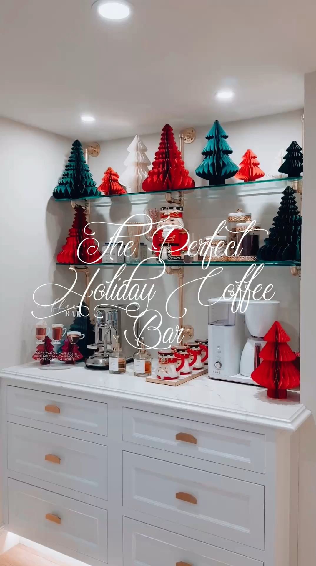 Darlings, welcome to my Christmas Coffee Wonderland! 🎄✨
This year, I’ve elevated my coffee bar game with these chic origami paper trees—aren’t they divine? Lightweight, colorful, and perfectly festive, they create a holiday backdrop that’s oh-so-effortlessly elegant.
Front and center, we have the star performers: a regal nutcracker cookie jar brimming with decadent chocolates (a necessity, obviously), paired with matching mugs that scream, “Fill me with hot cocoa and marshmallows!” 🍫☕ Because, really, what’s Christmas without a little indulgence?
Of course, my English Christmas teas have made their grand appearance—they’re the crown jewel of any refined morning ritual. And just look at how those gold-accented jars of treats add a touch of luxury to the shelves. Everything feels so cohesive, yet delightfully festive, don’t you think?
Looking to bring this magic to your own coffee nook? SHOP this post  to style your coffee bar like a true holiday hostess.
Here’s to sipping in style this season! Stay fabulous and chic! ✨🎄