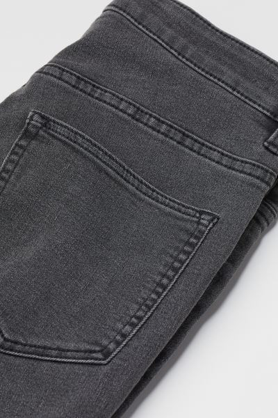 Jeans in washed superstretch denim with a high waist. Zip fly with button, mock front pockets, an... | H&M (US + CA)